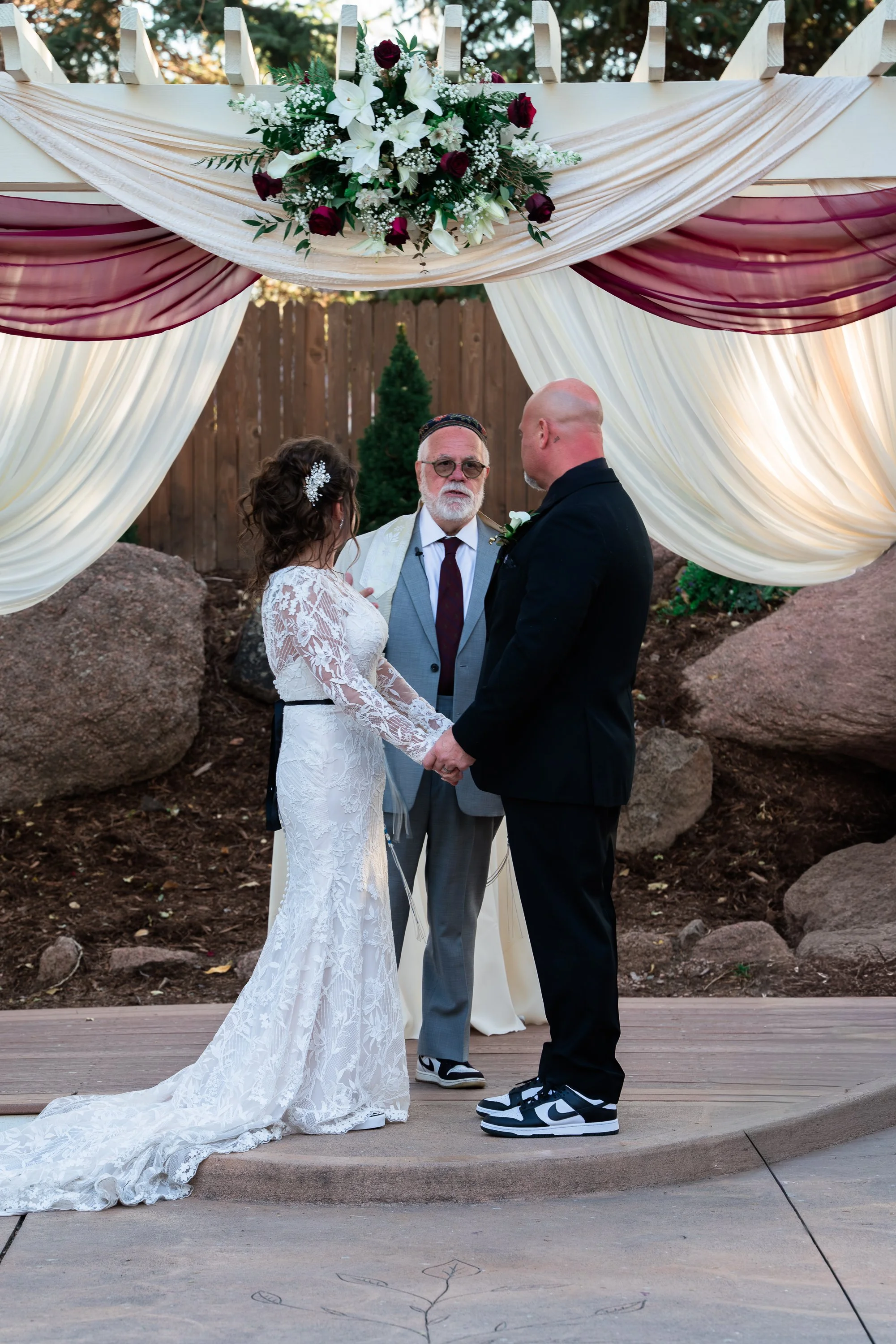 Bride and Groom Holding hands at the Alter 