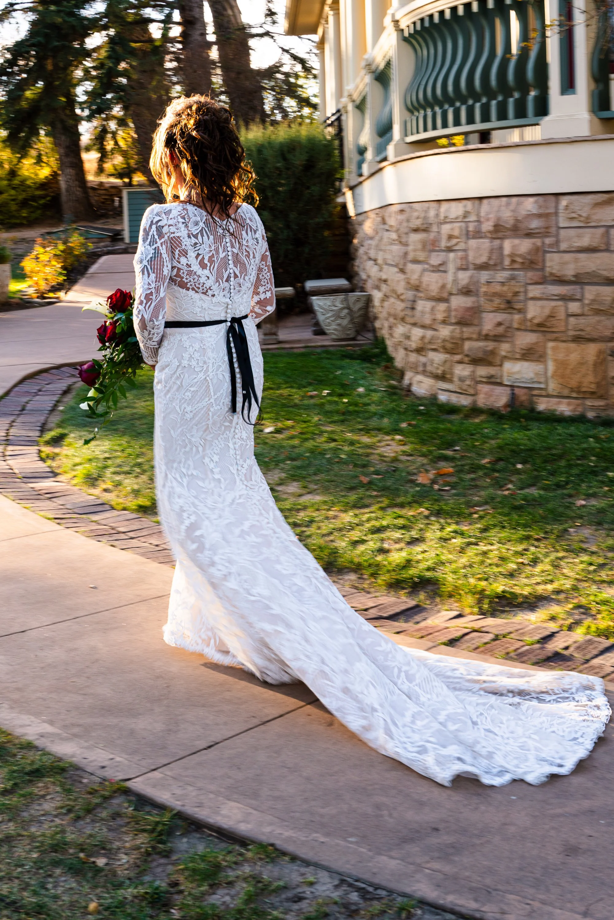 Back of bride as she walks down outdoor path