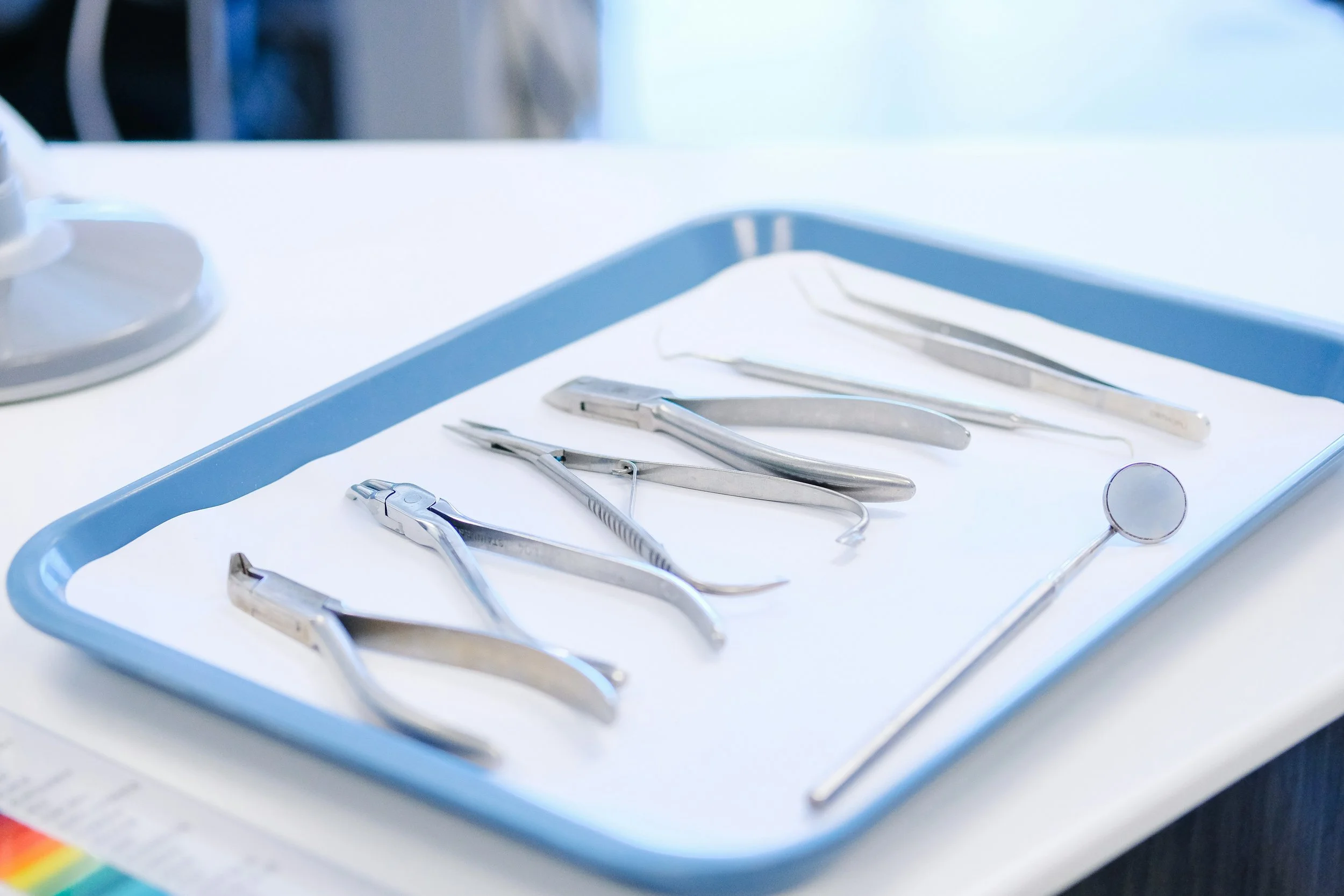 Close-up of dental instruments on a tray, used for tooth extraction procedures at Dee Why Dental.