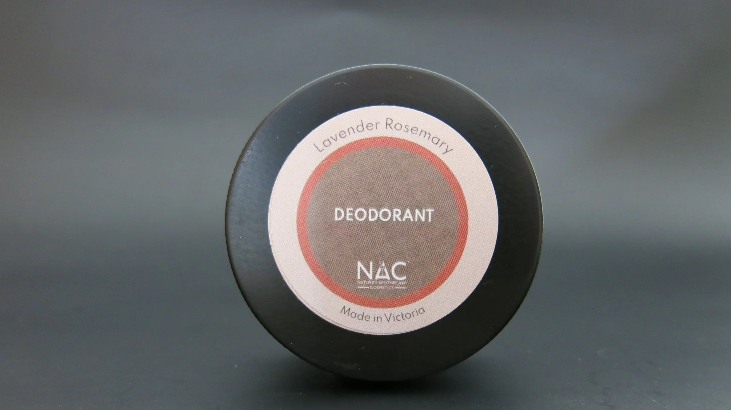 A black tin with a round label reading Lavender Rosemary Deodorant made in Victoria