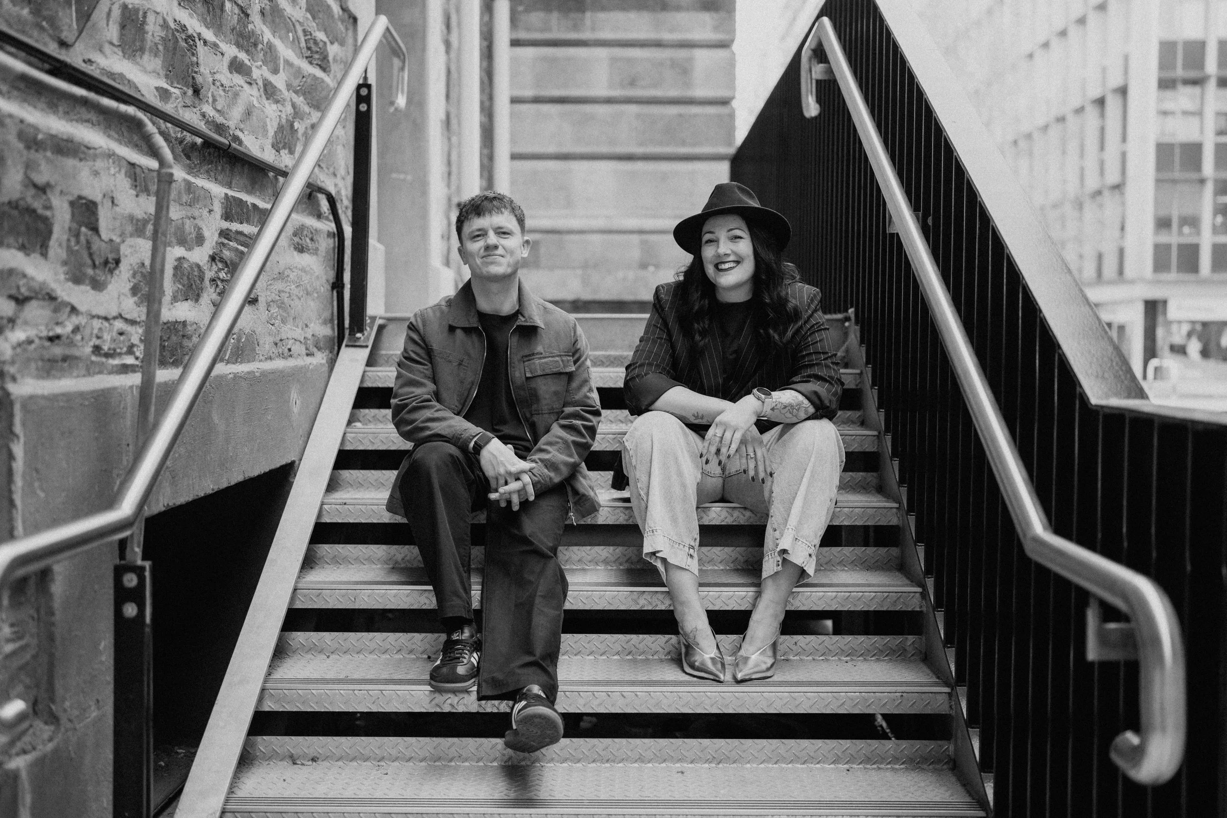 Brad and Karina, owners of Brad and Karina Weddings, sitting on stairs in Adelaide