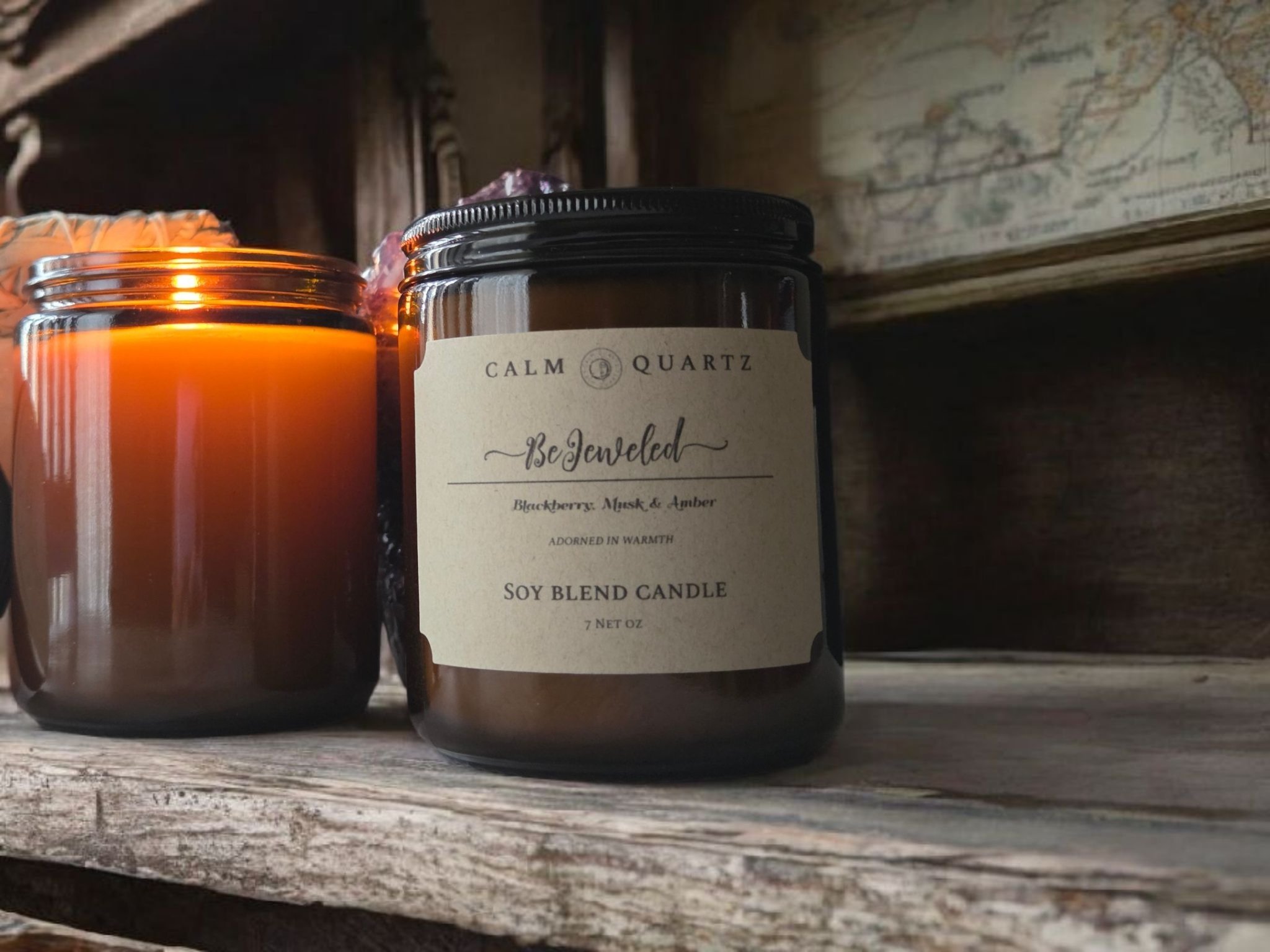 7oz candle in an amber jar on a wood table against a white wall