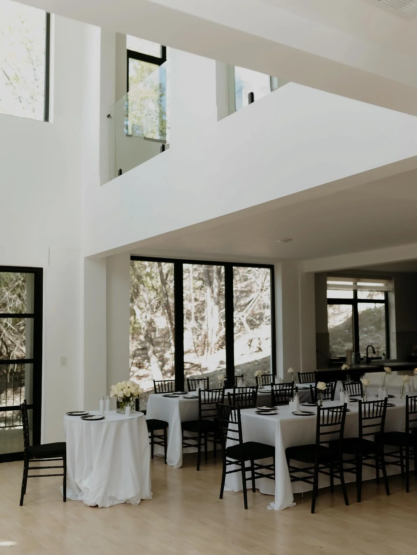 Black Chiavari chairs, crisp white linens, candlelight, and simple white florals. Timeless details that let the space and the moment shine.

Featured rentals:
&bull;Black Chiavari Chairs
&bull;8ft Banquet Tables
&bull;Bistro Tables