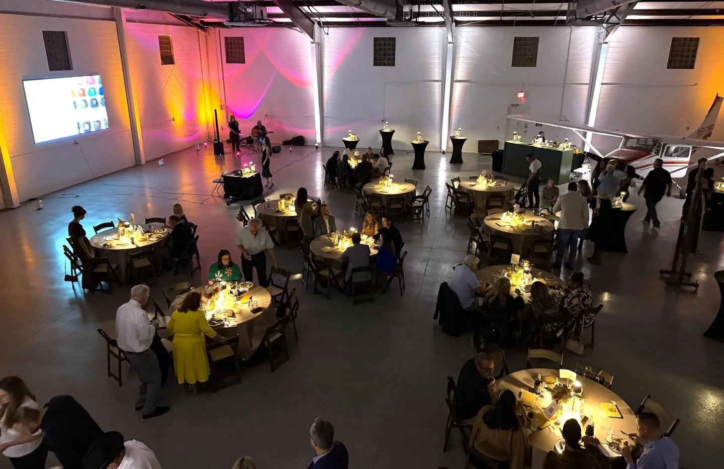 From airplane hangar to gala 🕯️

Events like this are a reminder that with the right rentals and lighting, almost any space can become an unforgettable venue.

Featured Rentals
&bull; 8ft Green Bar
&bull; Uplighting
&bull; Fruitwood Chairs
&bull; 60