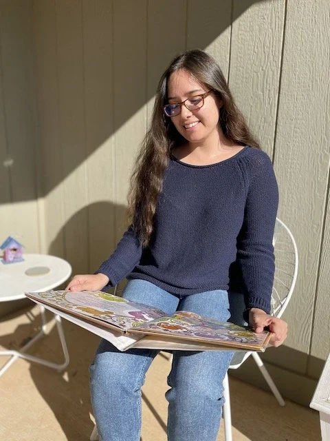 Sara Eliason, SLP, reading illustrated story to promote children's speech-language skills