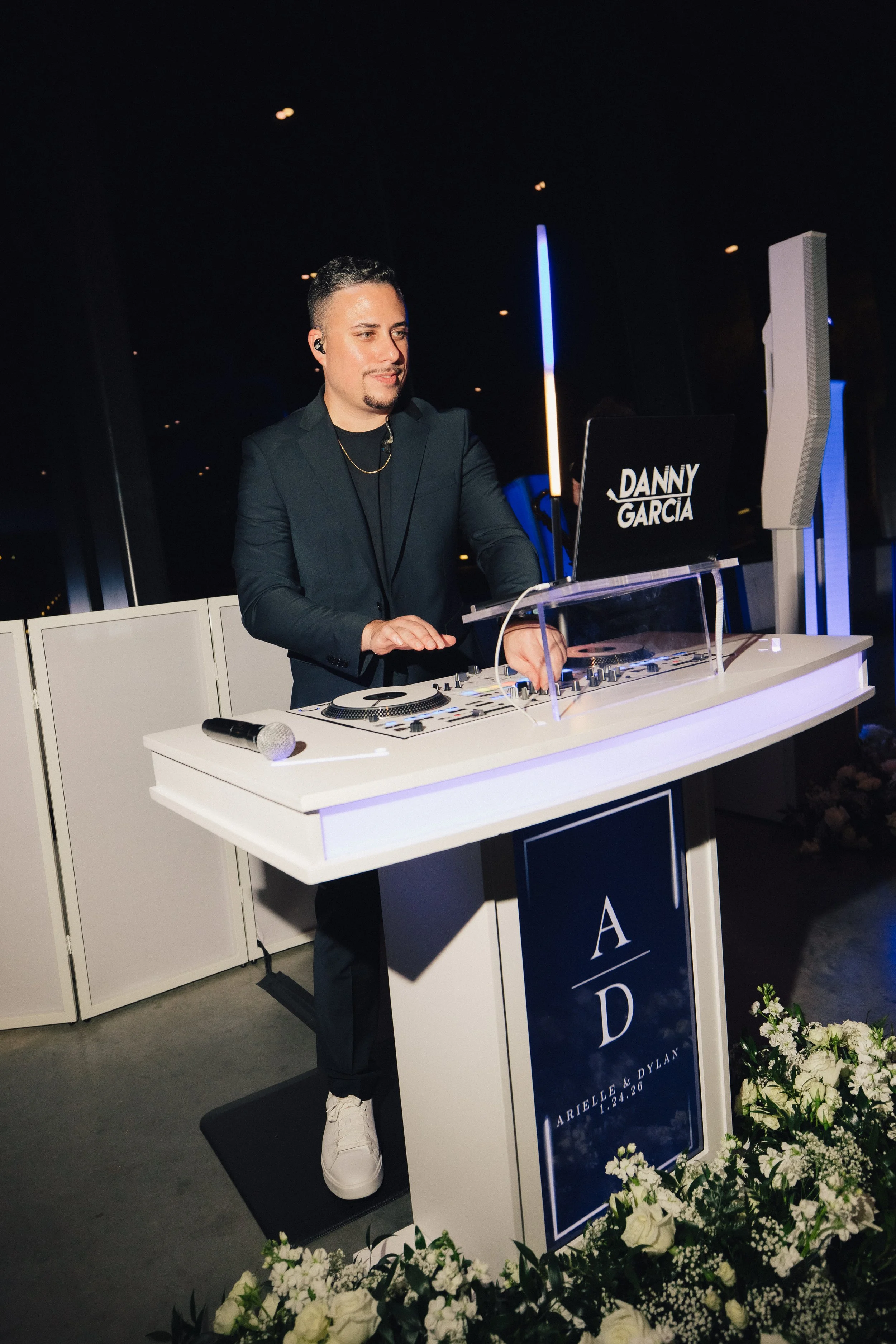 DJ Danny Garcia performing at a wedding reception in Orlando with his professional DJ setup and custom DJ Booth