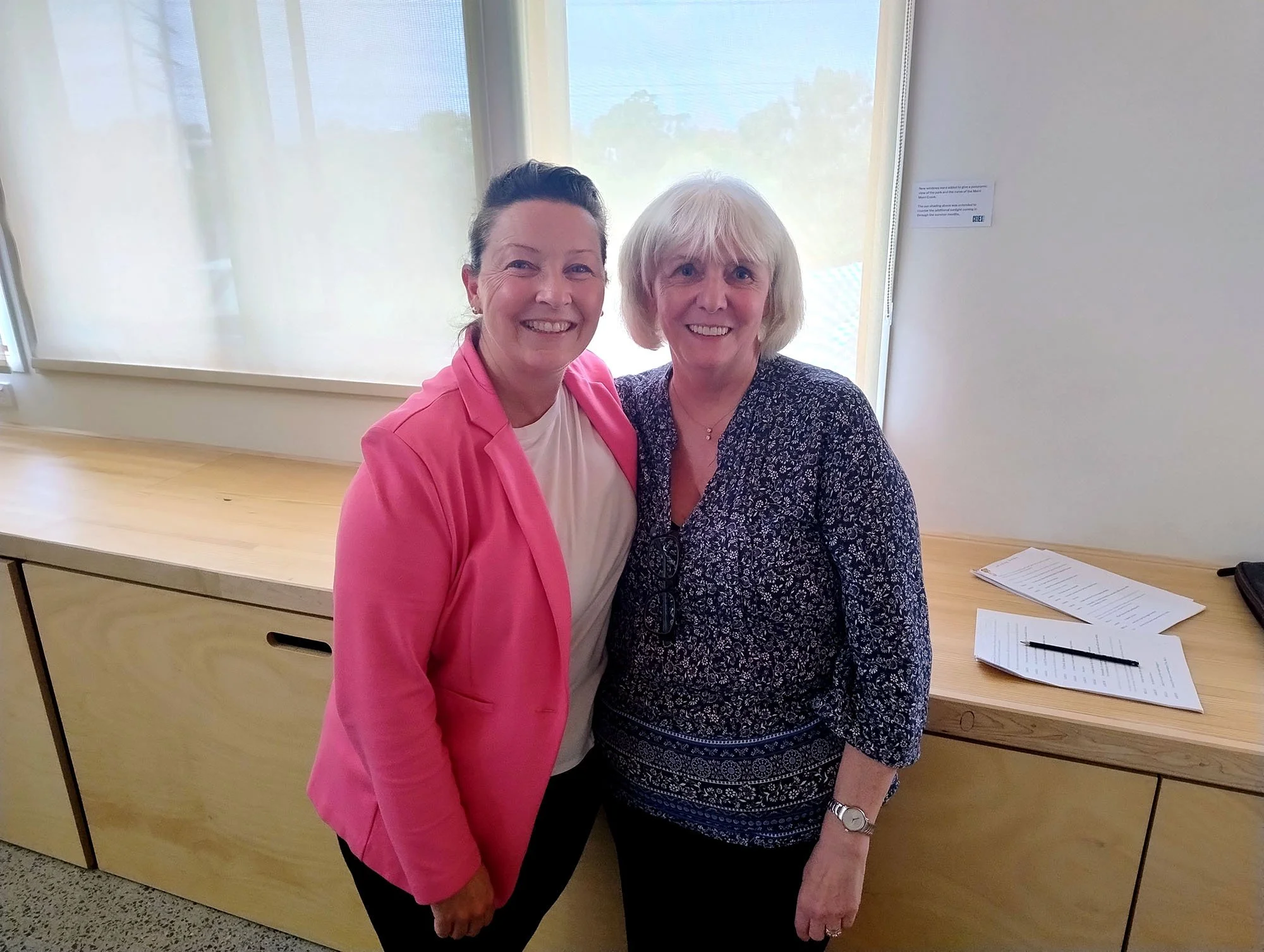 Carol Matthews and Jemima Richards standing with arms around one another