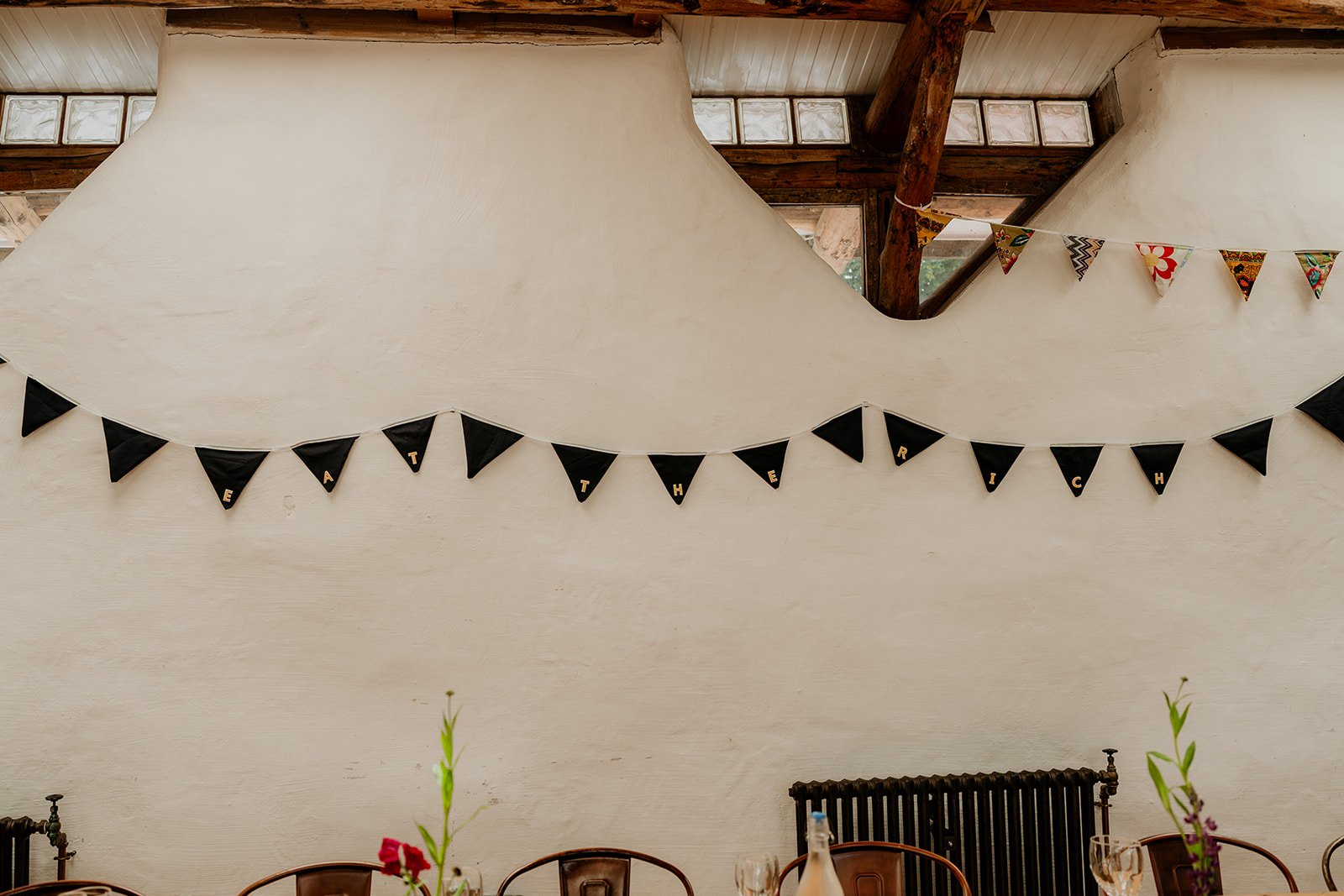 a banner at a wedding that reads eat the rich