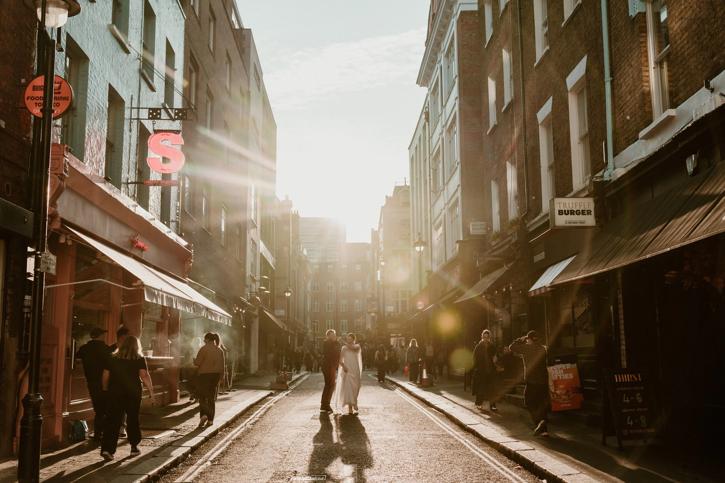A bride and groom dancing in the streets at their October Wedding London