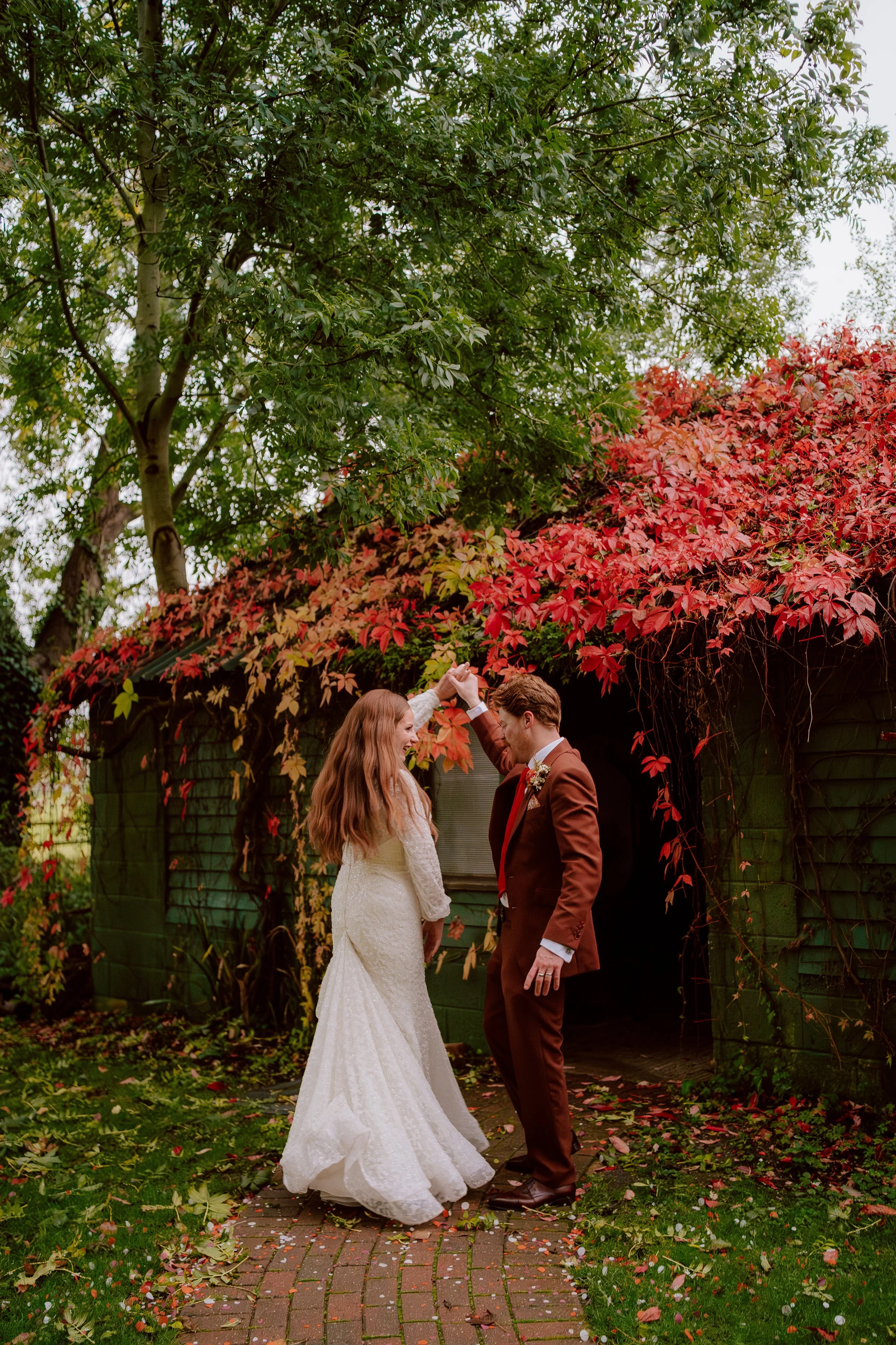 A bride and groom dancing OctoberAutumnalWeddingColours