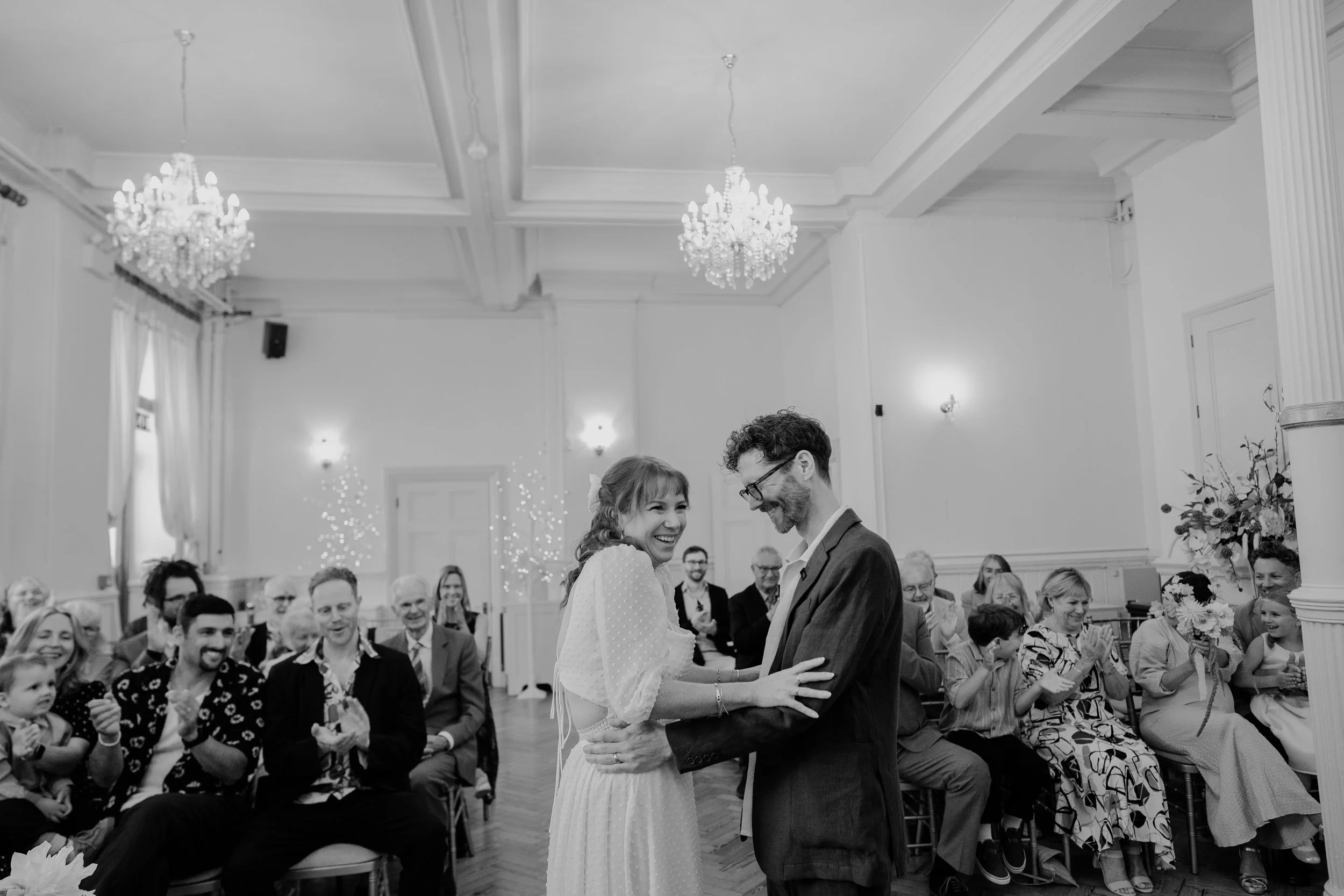 A couple smiling in their brighton town hall regency room ceremony