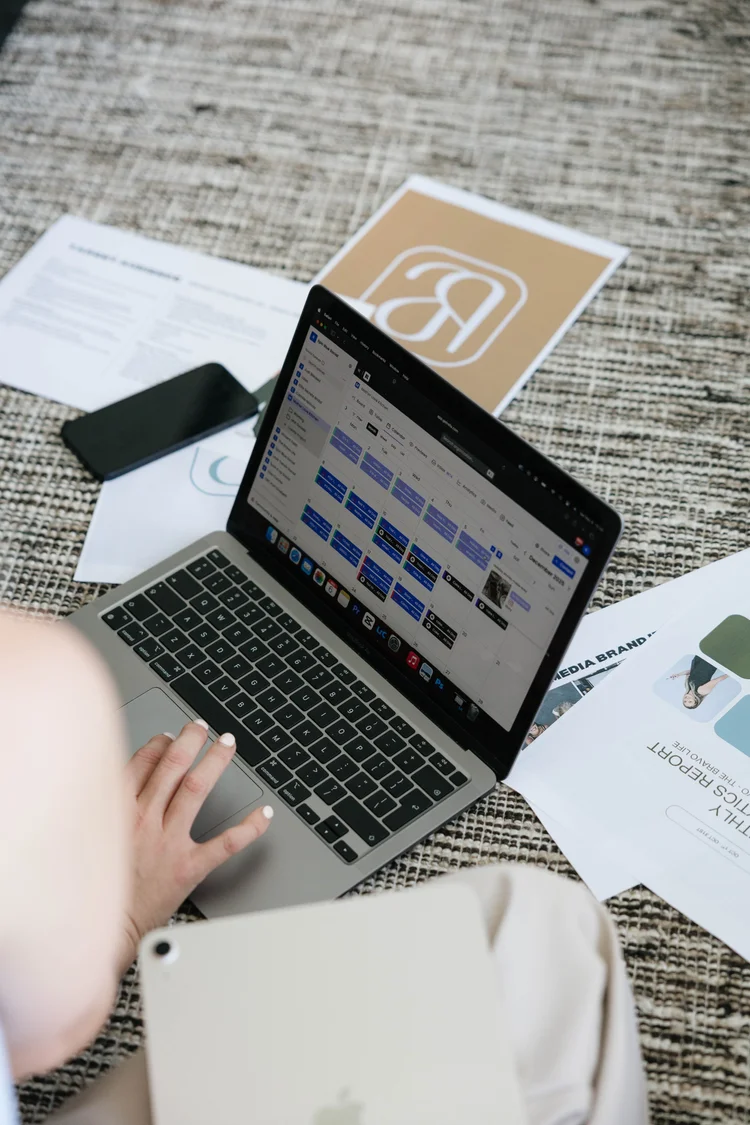 Close-up of hands working on a laptop