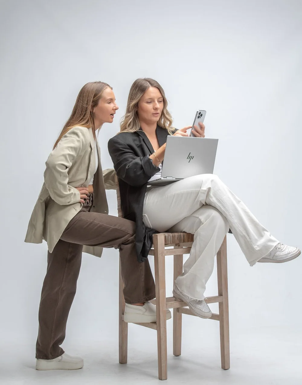 Two women reviewing content together on a laptop