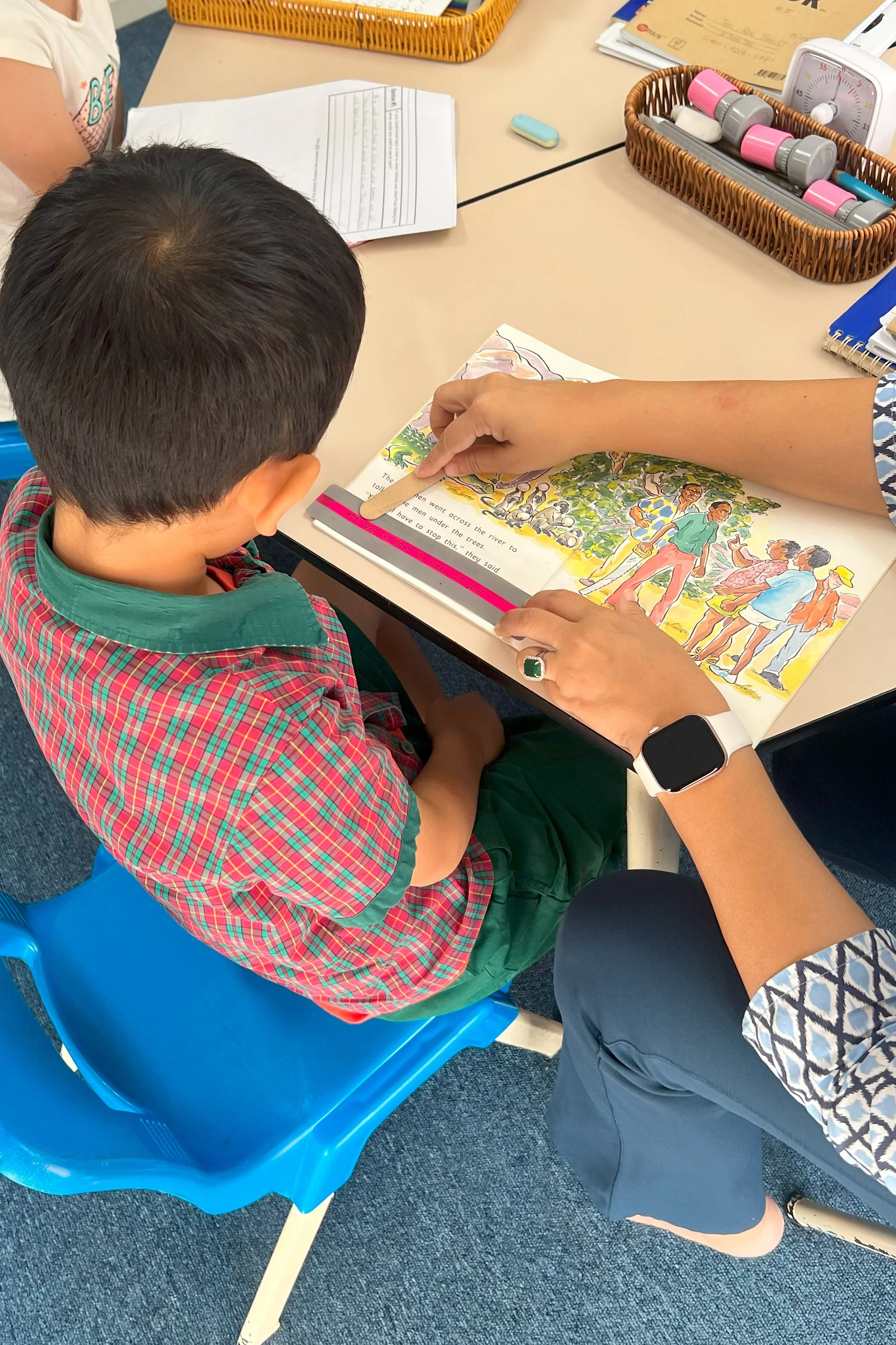 Boy Reading With Teacher