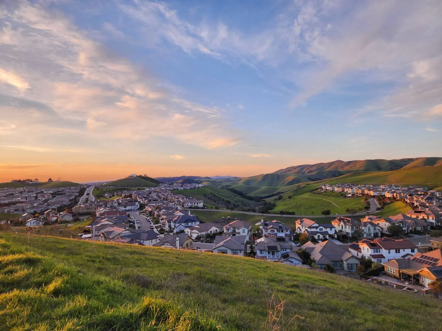 Scenic hillside residential community featuring homes surrounded by rolling hills and natural landscapes.
