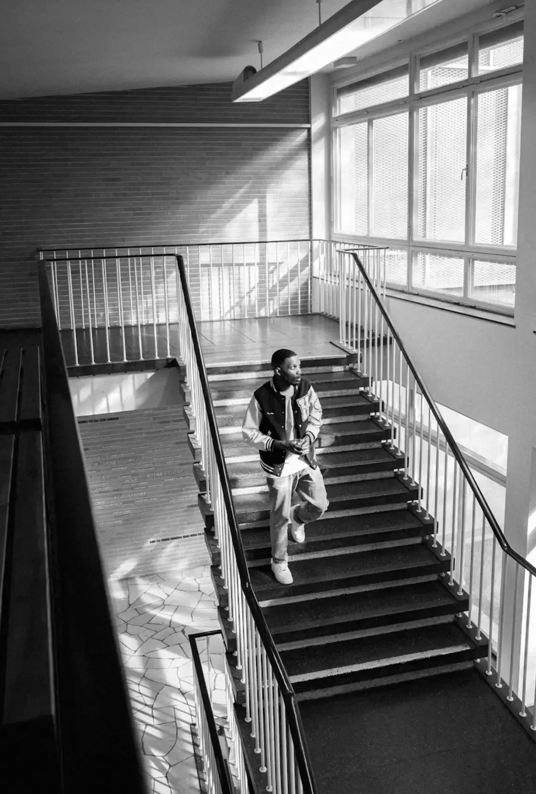 University athlete in varsity letterman jacket representing Canadian athletic department communication training