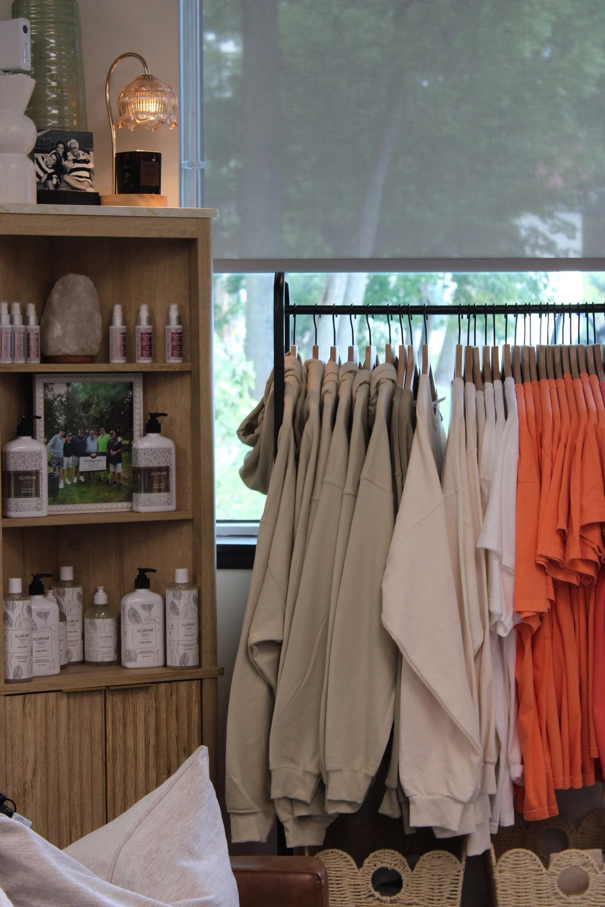 Front entrance area of Mayor Salon showing hair care products and apparel for sale.