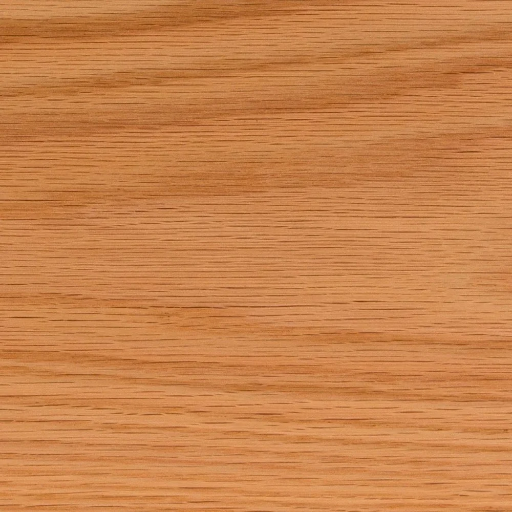 Close-up image of a wooden surface with a natural light brown color and visible wood grain.