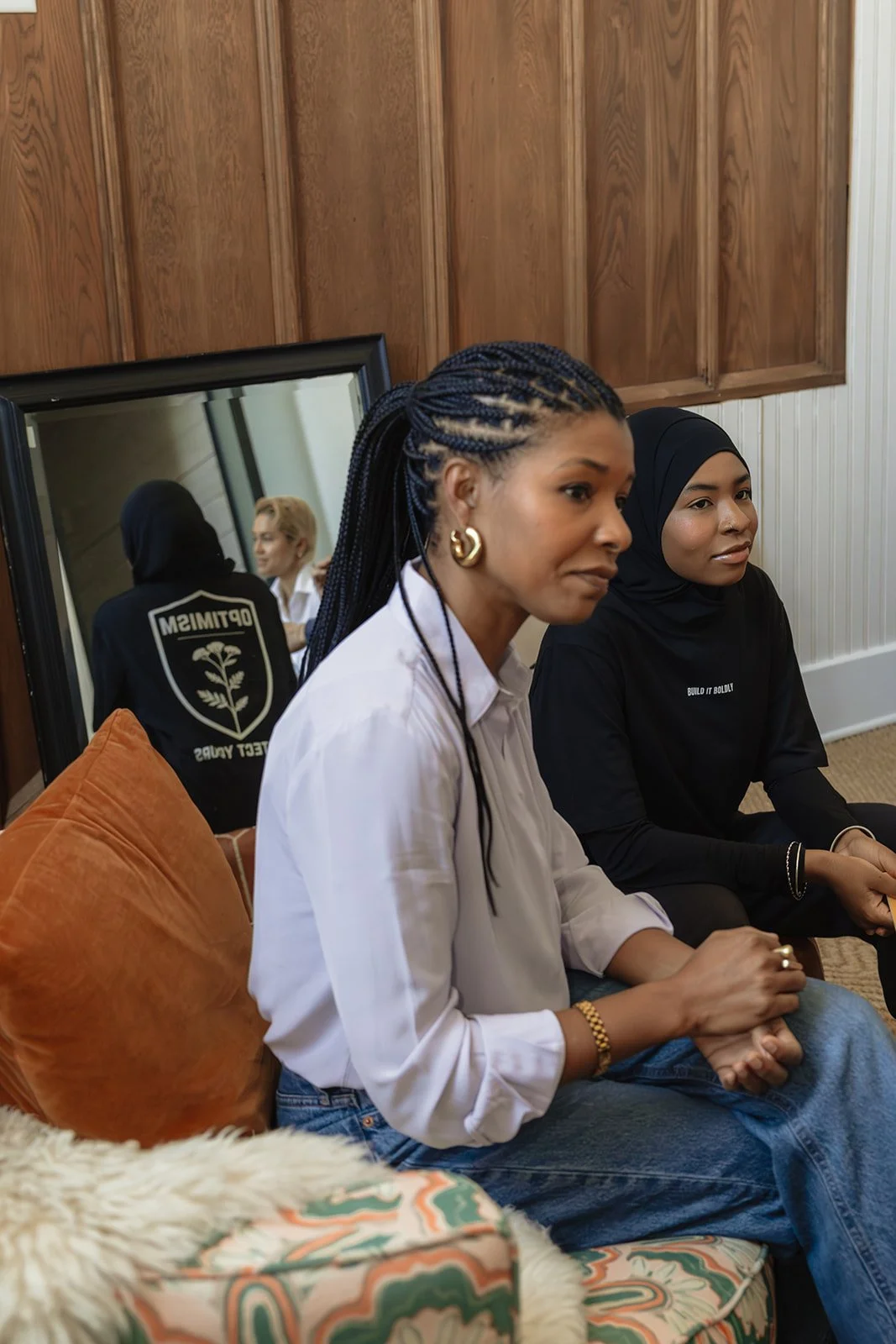 Kimberly McGlonn in conversation with another woman during a seated community discussion