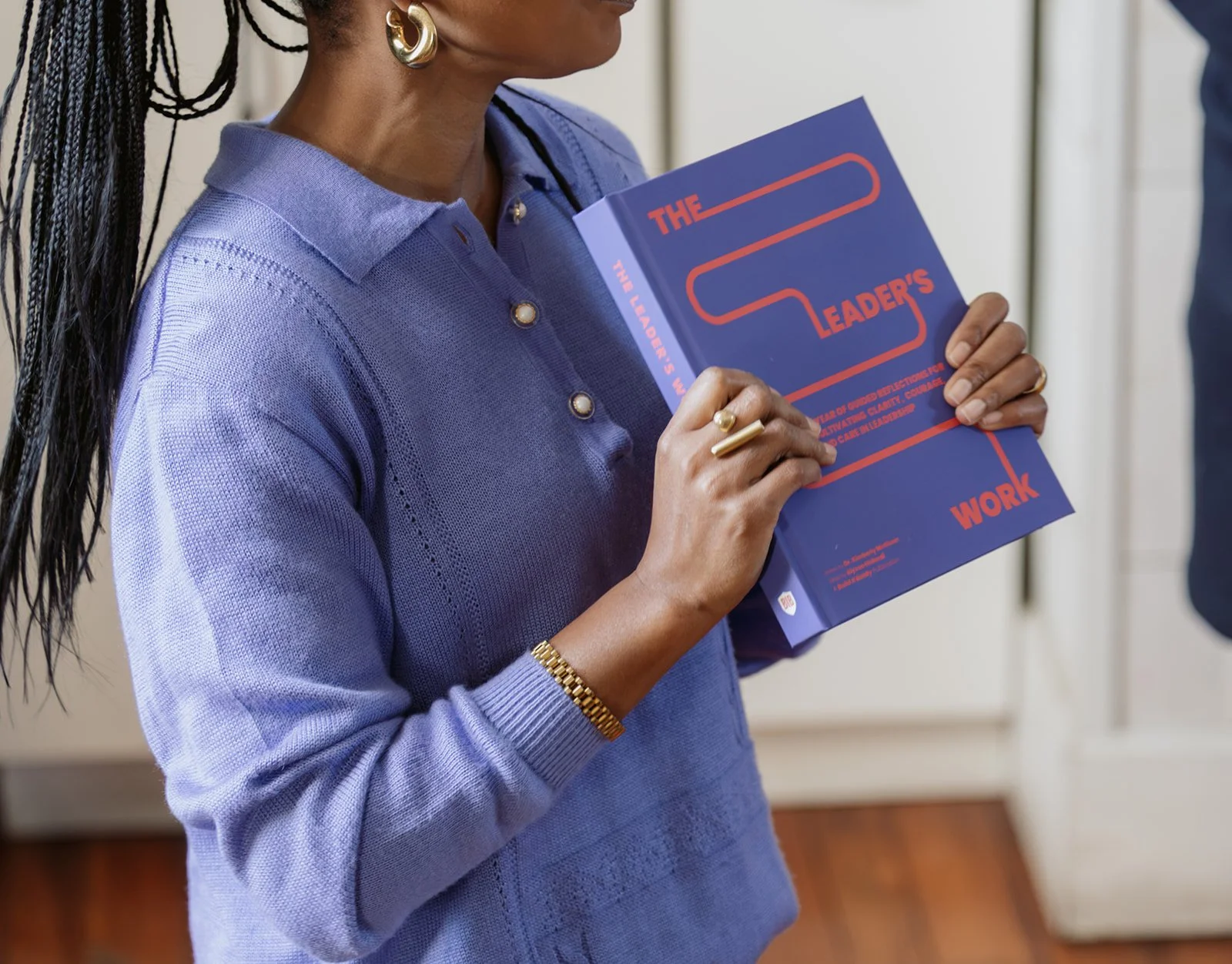 Kimberly McGlonn holding a copy of The Leader’s Work book