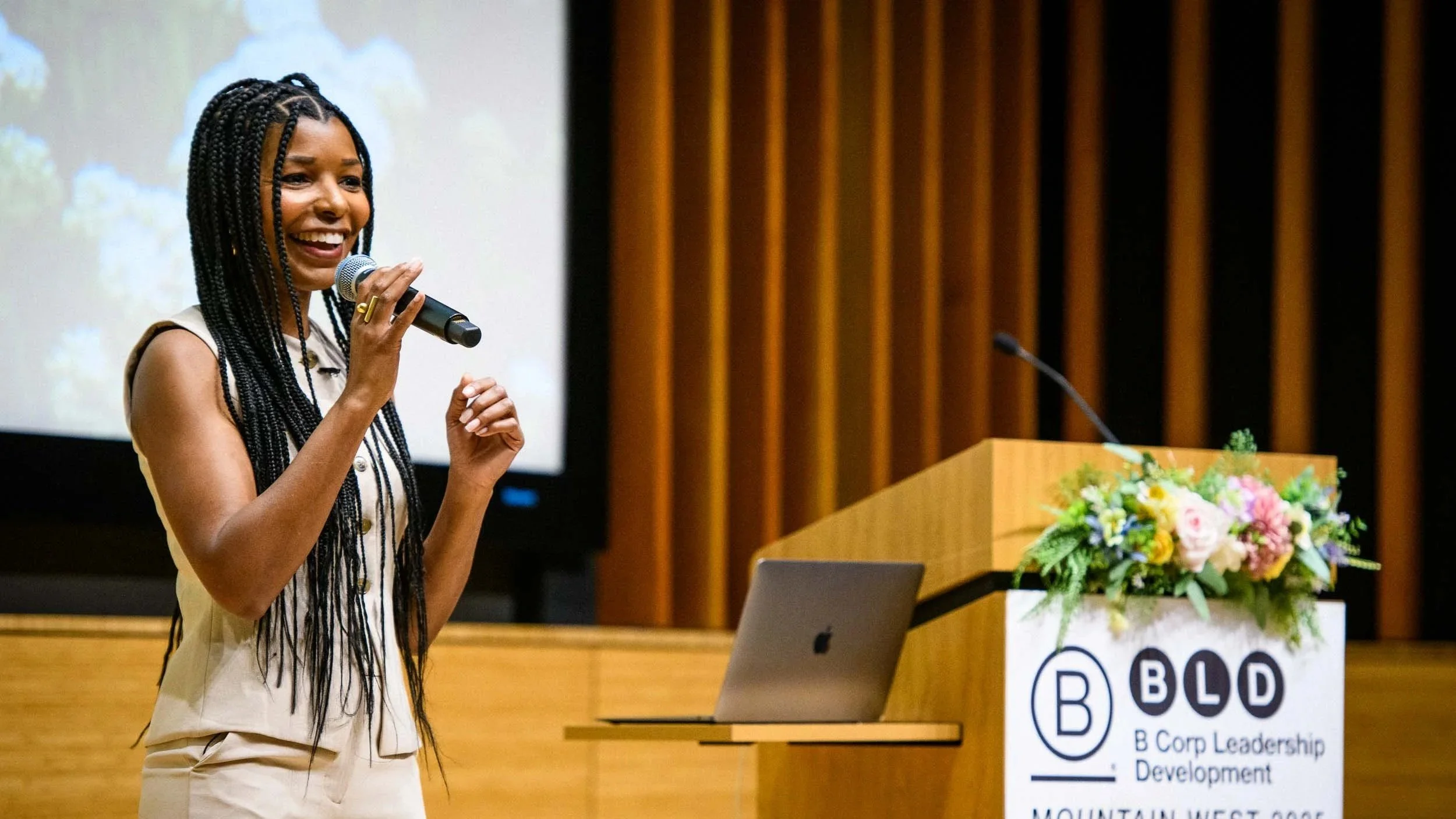 Dr. Kimberly McGlonn speaking beside a podium at a B Corp Leadership Development event