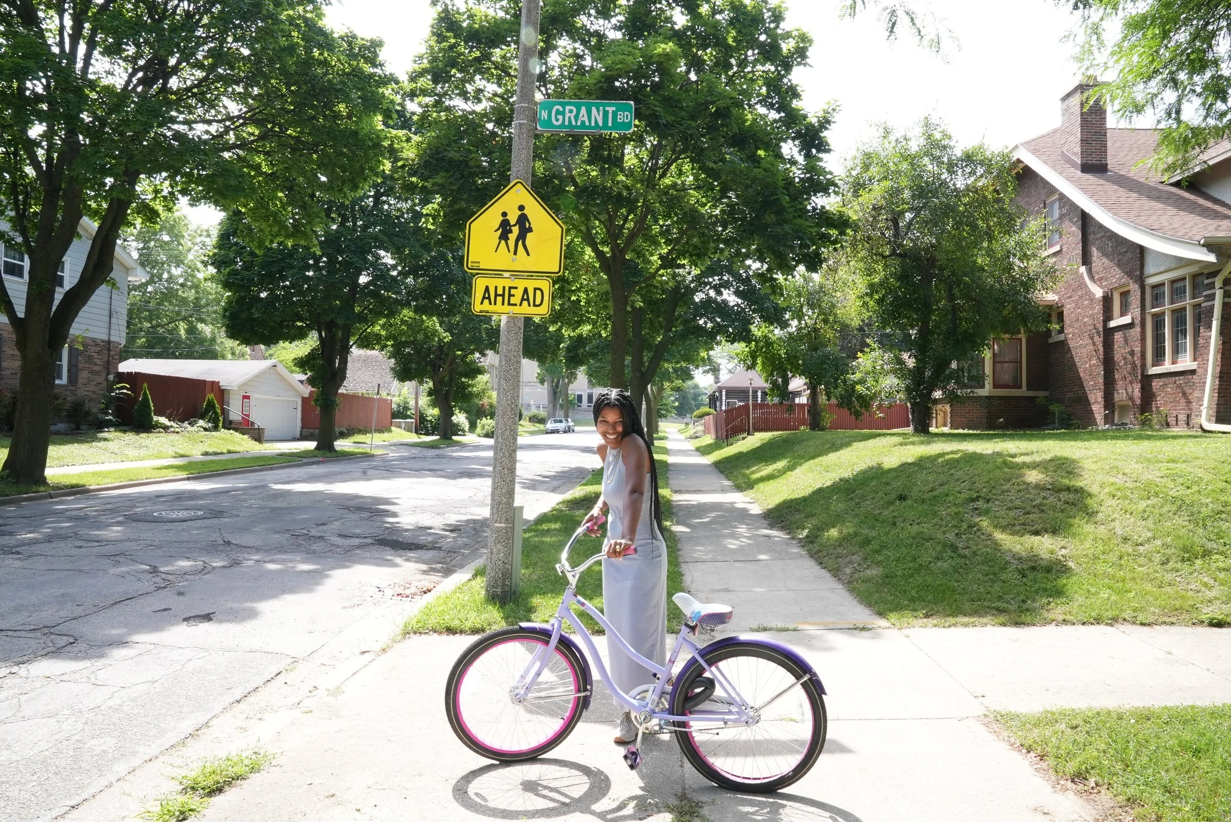 Dr. Kimberly McGlonn smiling with a bicycle on a neighbor
