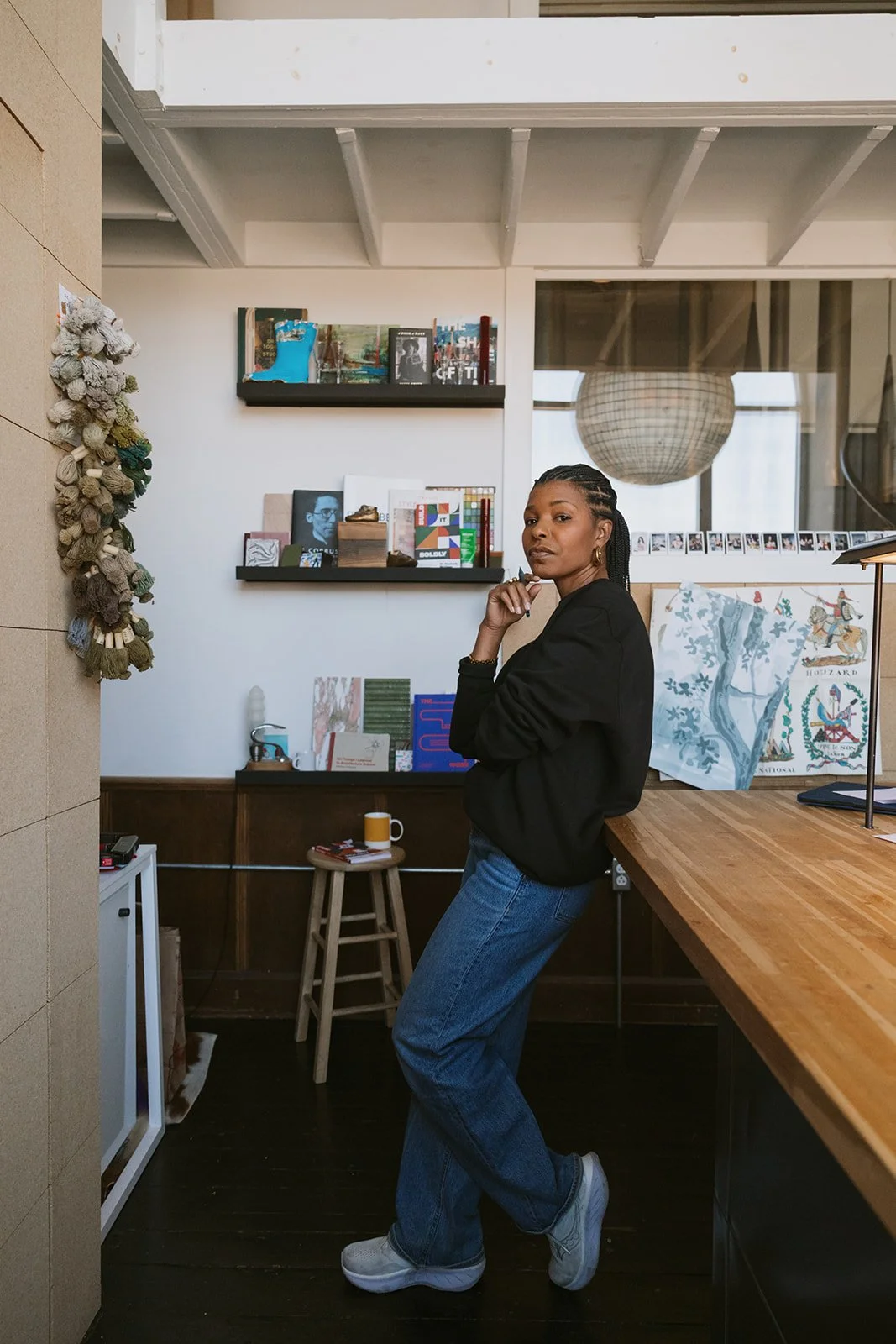 Kimberly McGlonn standing in a home office with books and artwork behind her