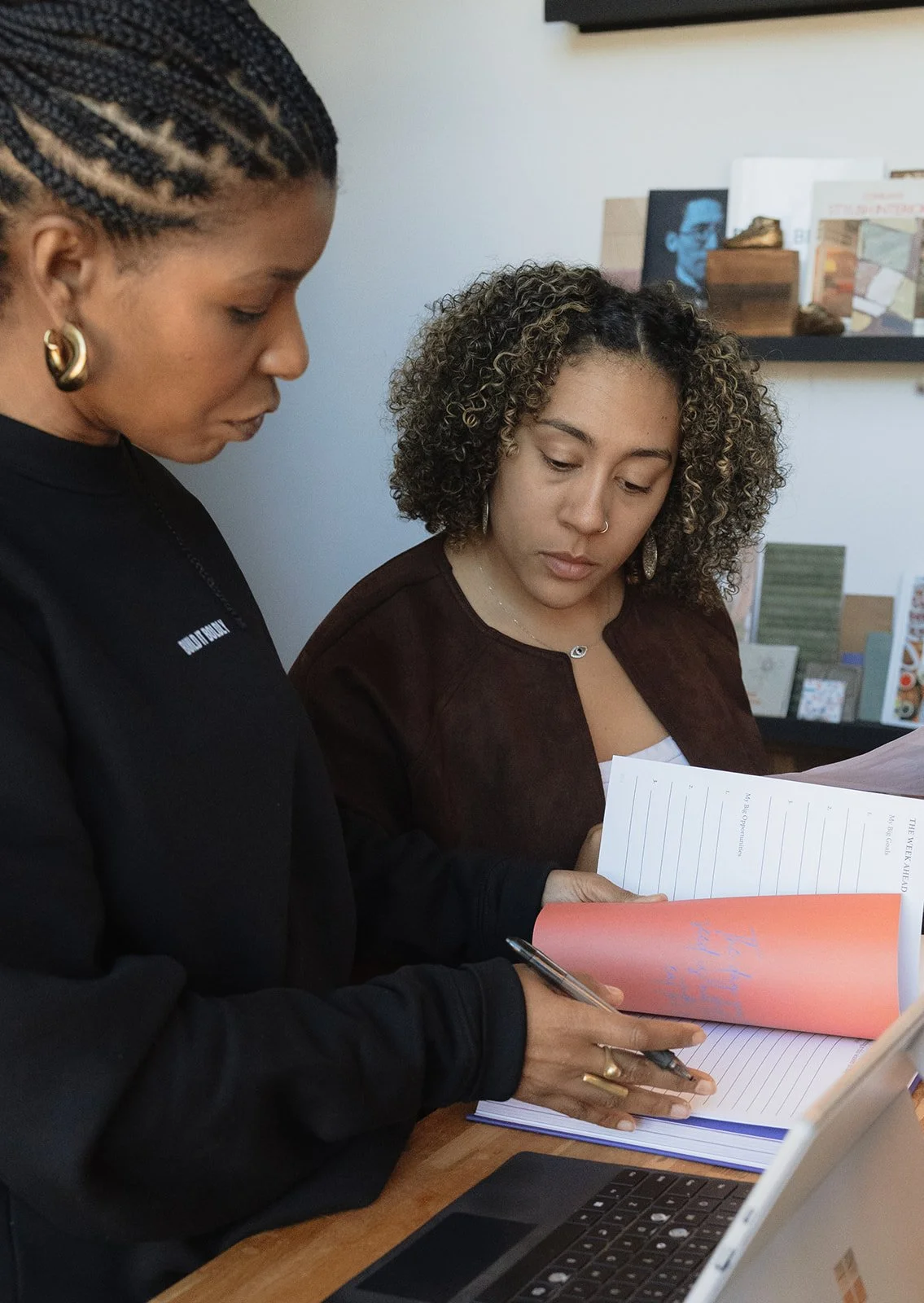 Two professionals reviewing documents and working together during a leadership strategy session