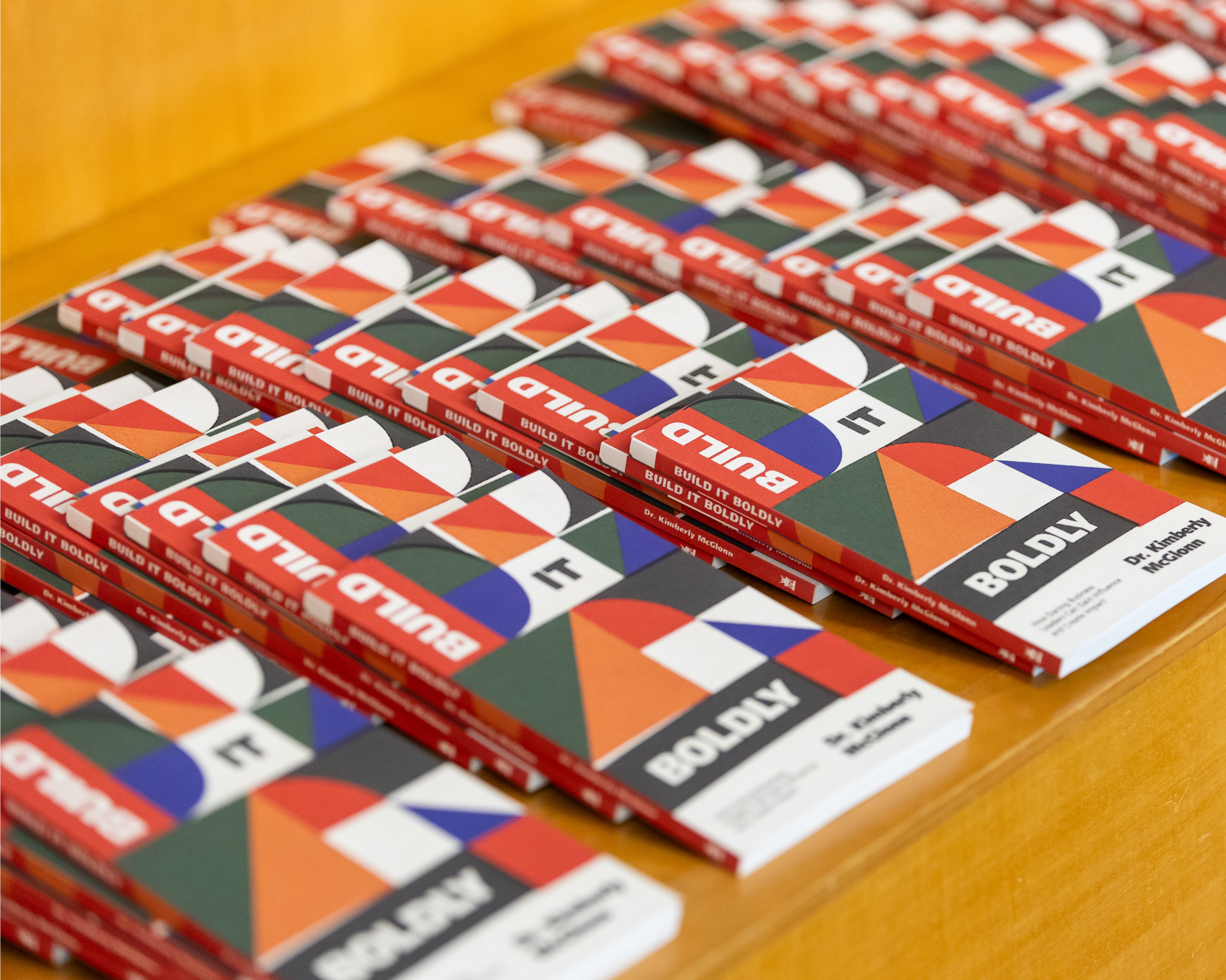 Multiple copies of Build It Boldly arranged on a display table