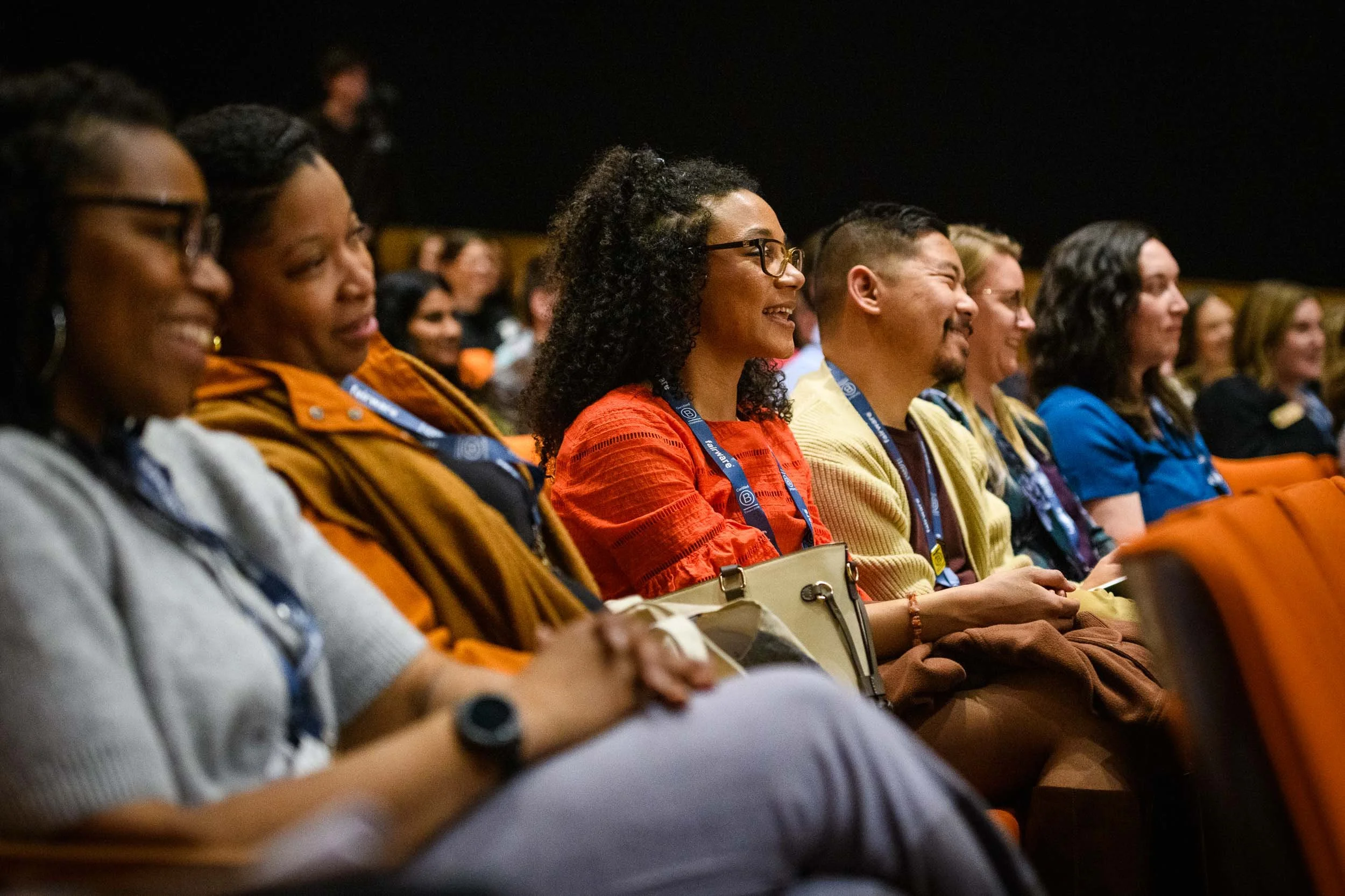 Conference attendees seated in an auditorium listening to a keynote presentation