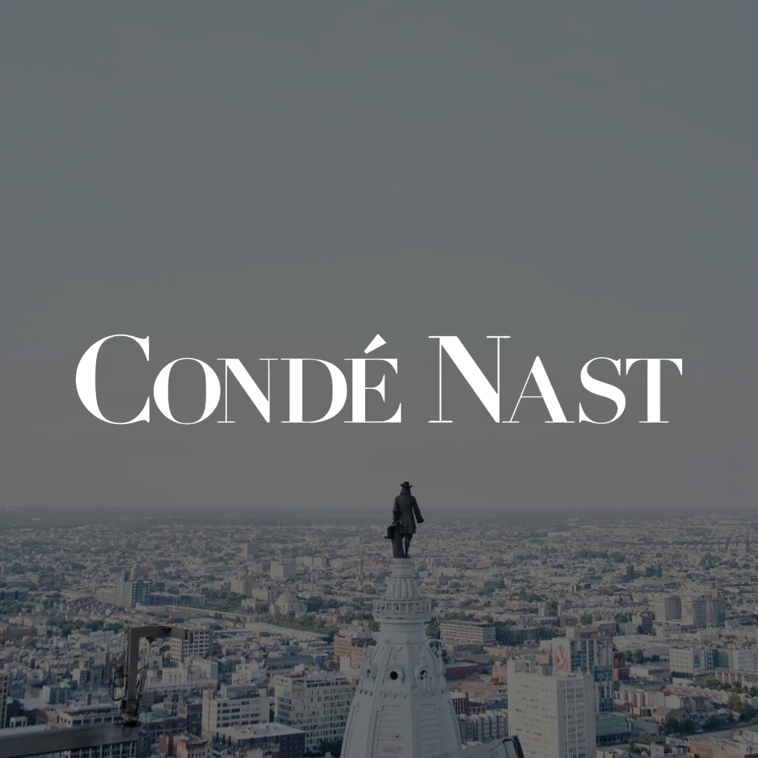 Condé Nast feature graphic over a view of the Philadelphia skyline