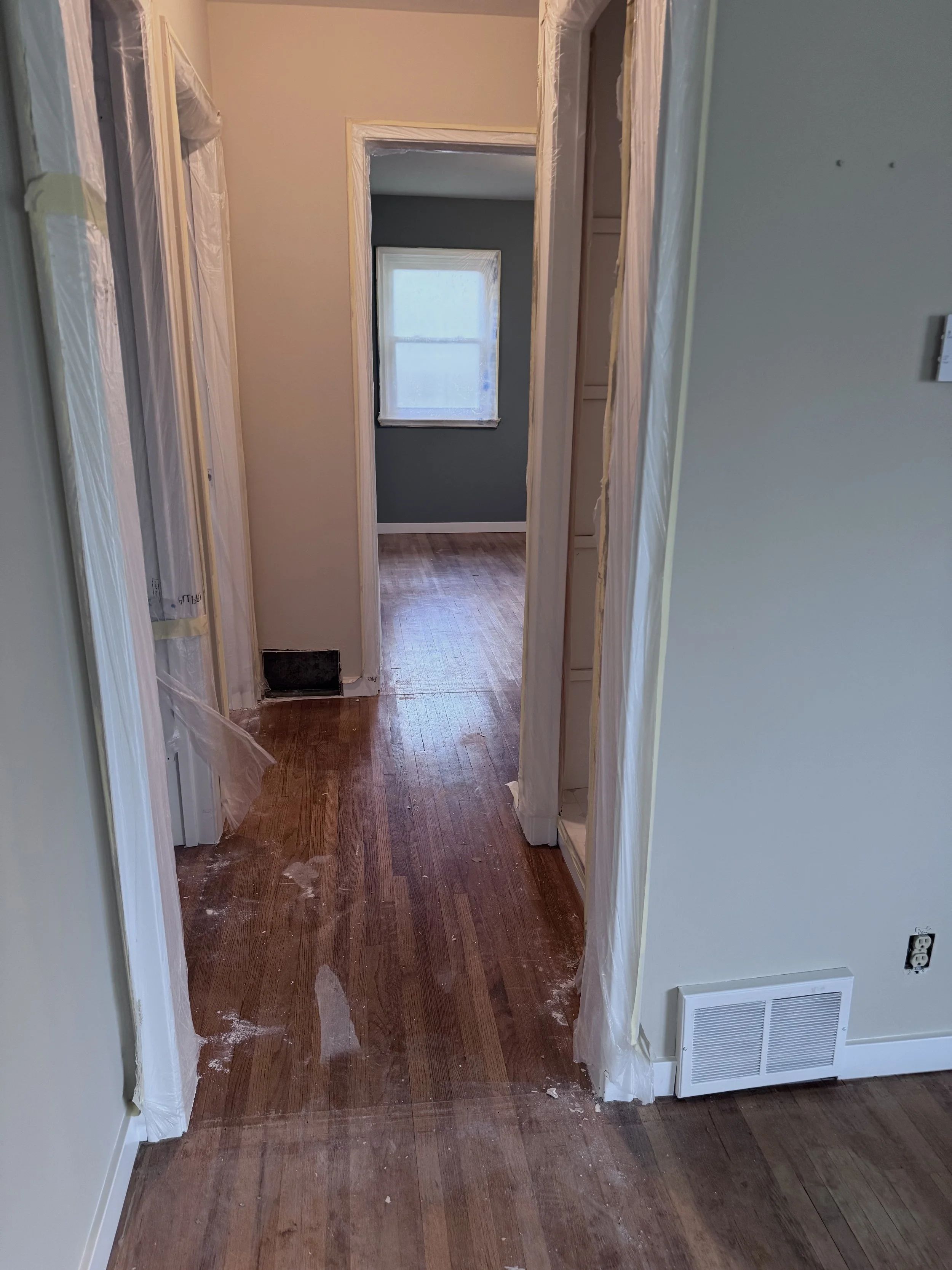 hallway view from living room worn floors.jpeg