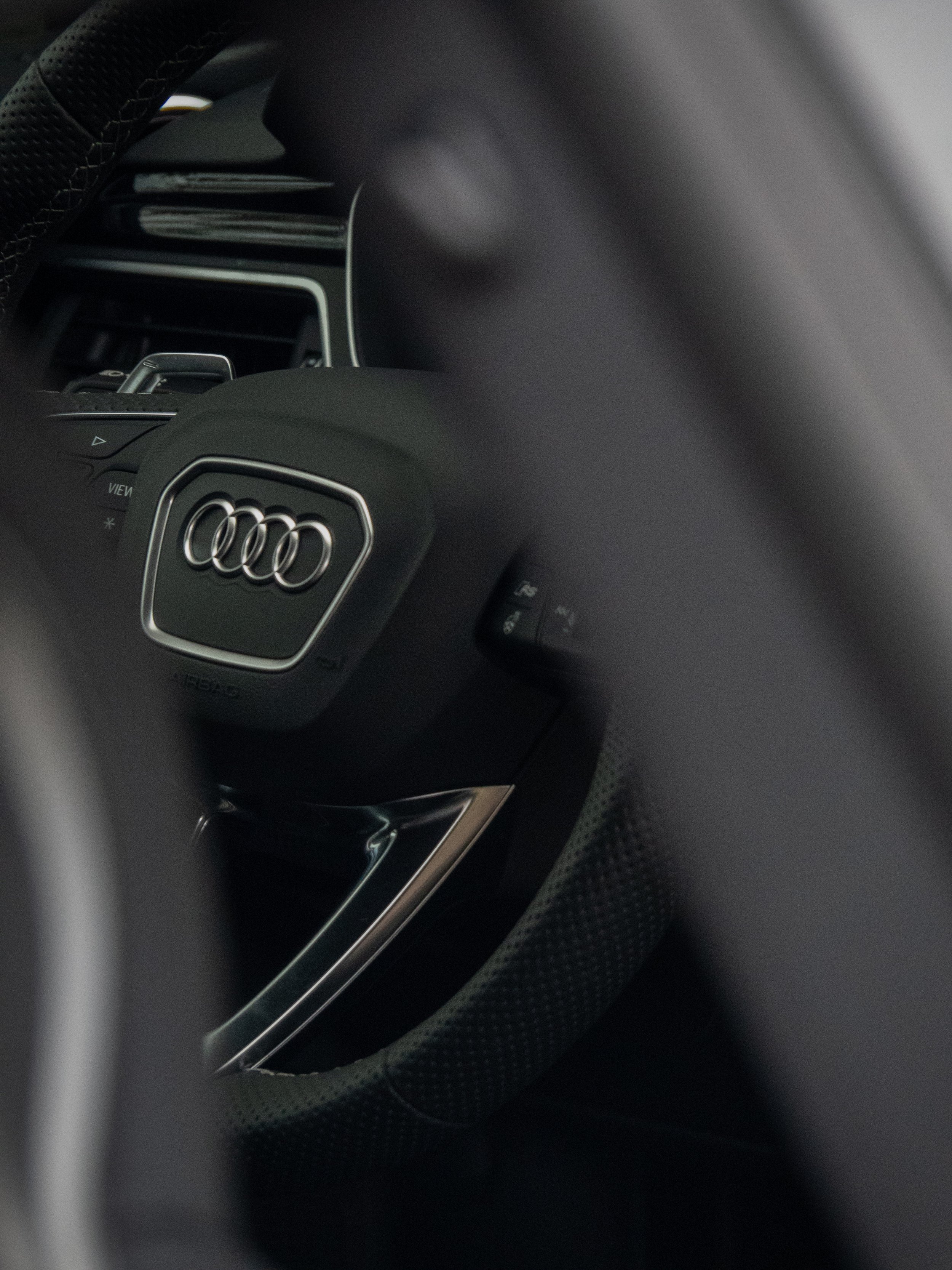Close-up of an Audi steering wheel with logo
