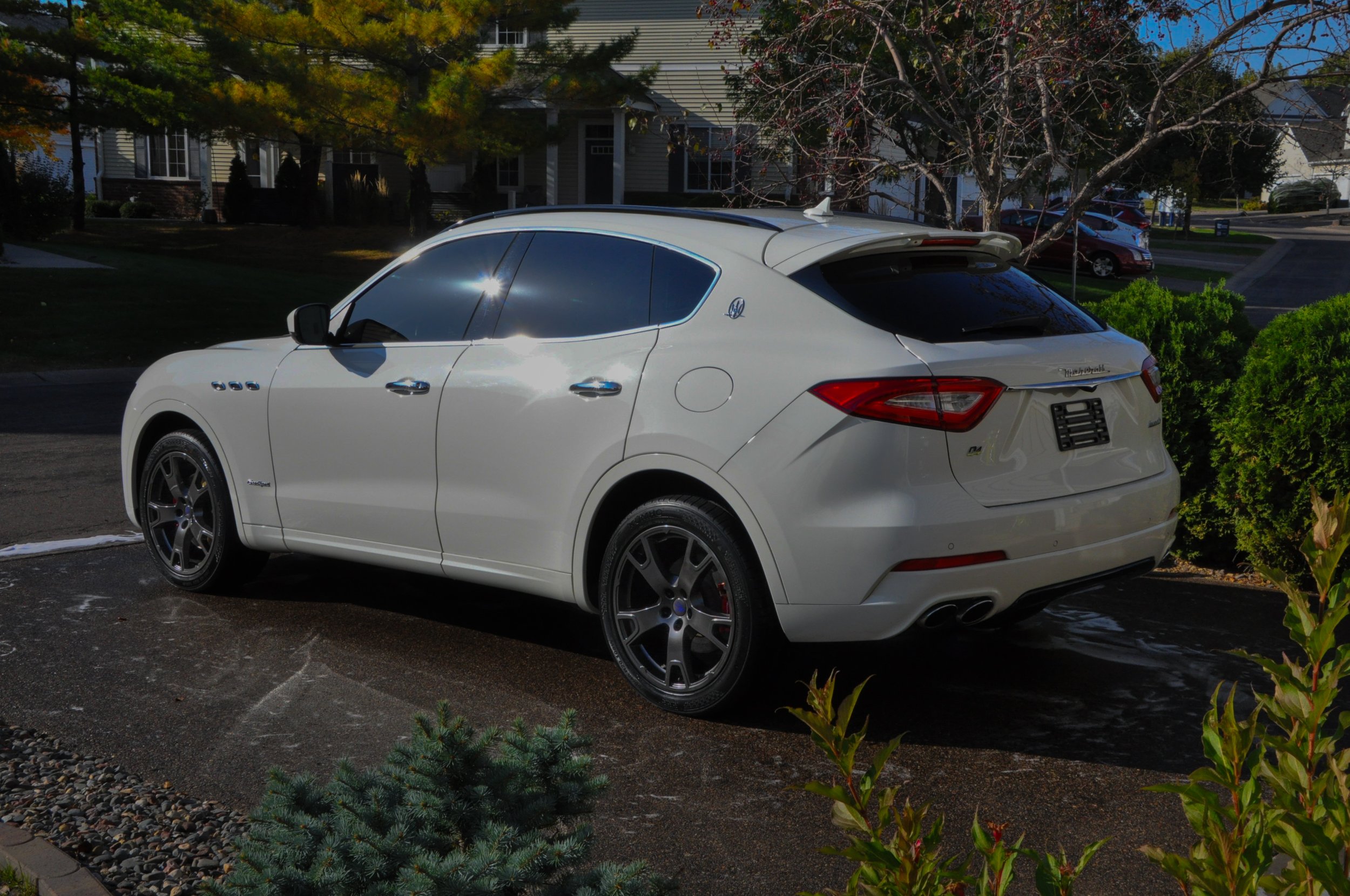 White Maserati Levante parked in a residential driveway