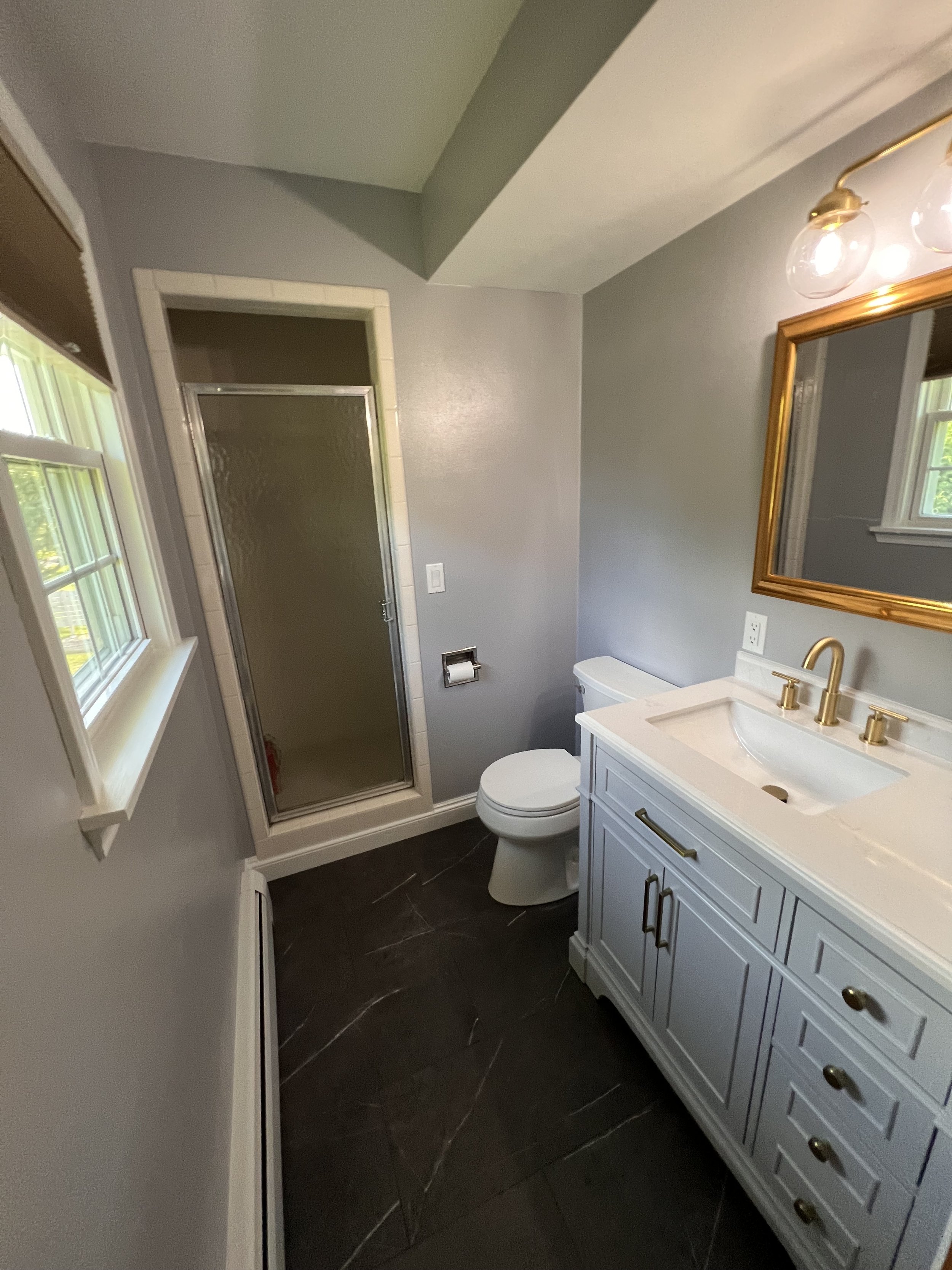 NEW VANITY, LIGHT, AND FLOORING MAKES AN OLD BATHROOM LOOK NEW.