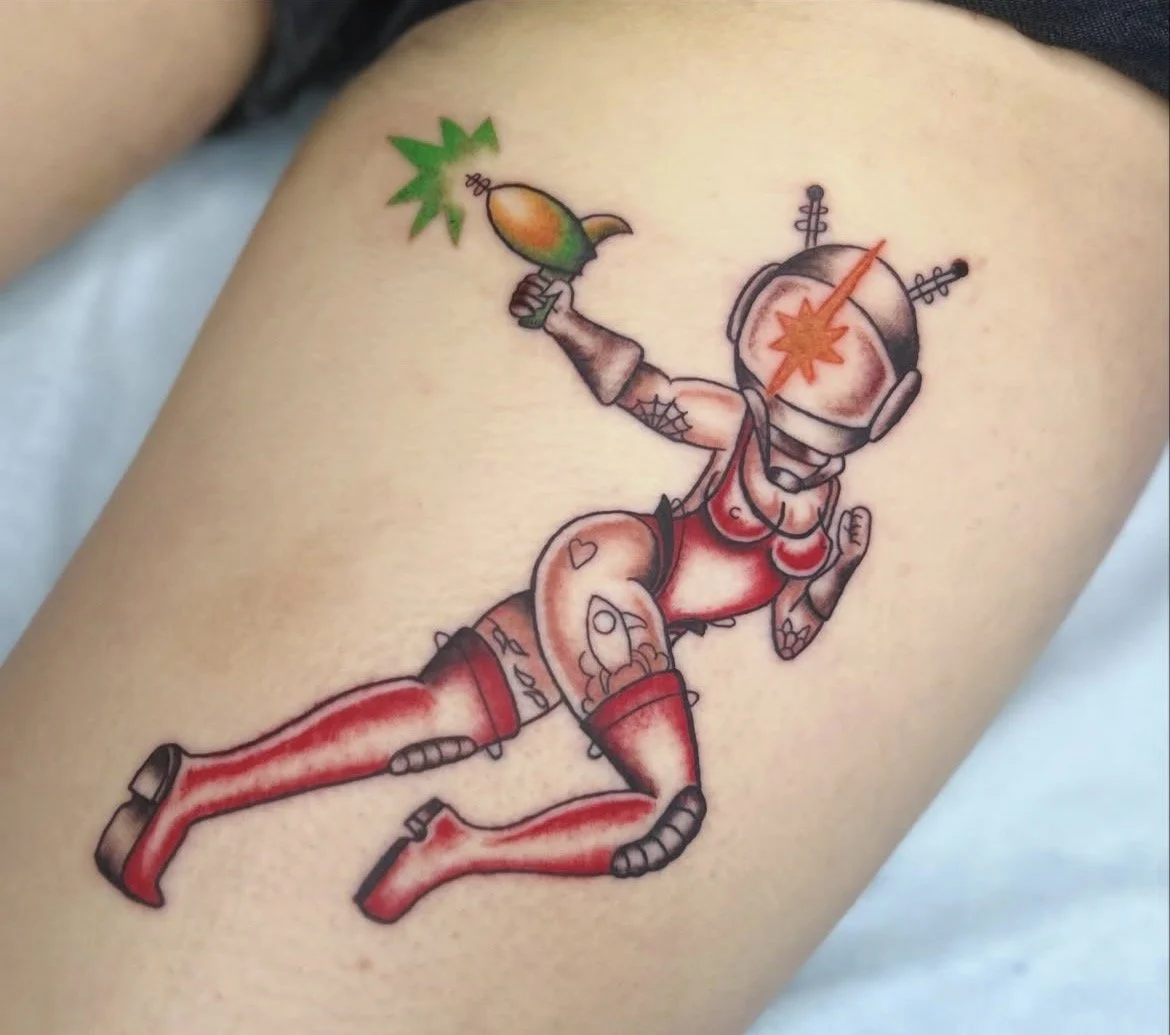 Tattoo of a cartoon astronaut with a bomb as a head, holding a green and brown bird, and jumping.