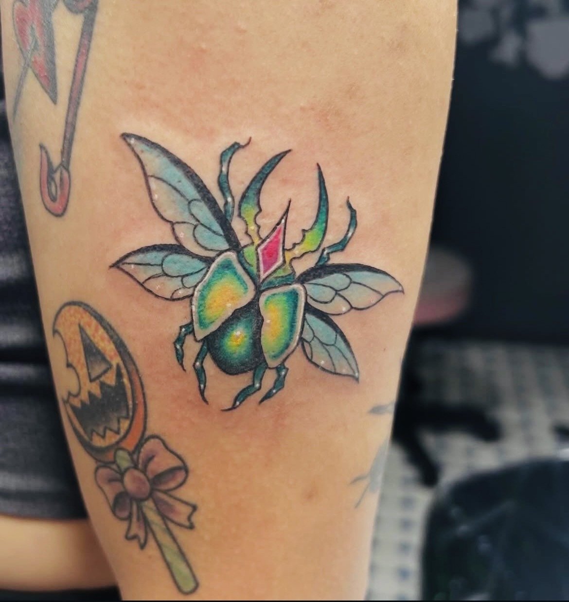 Colorful tattoo of a butterfly with intricate wings on someone's arm.