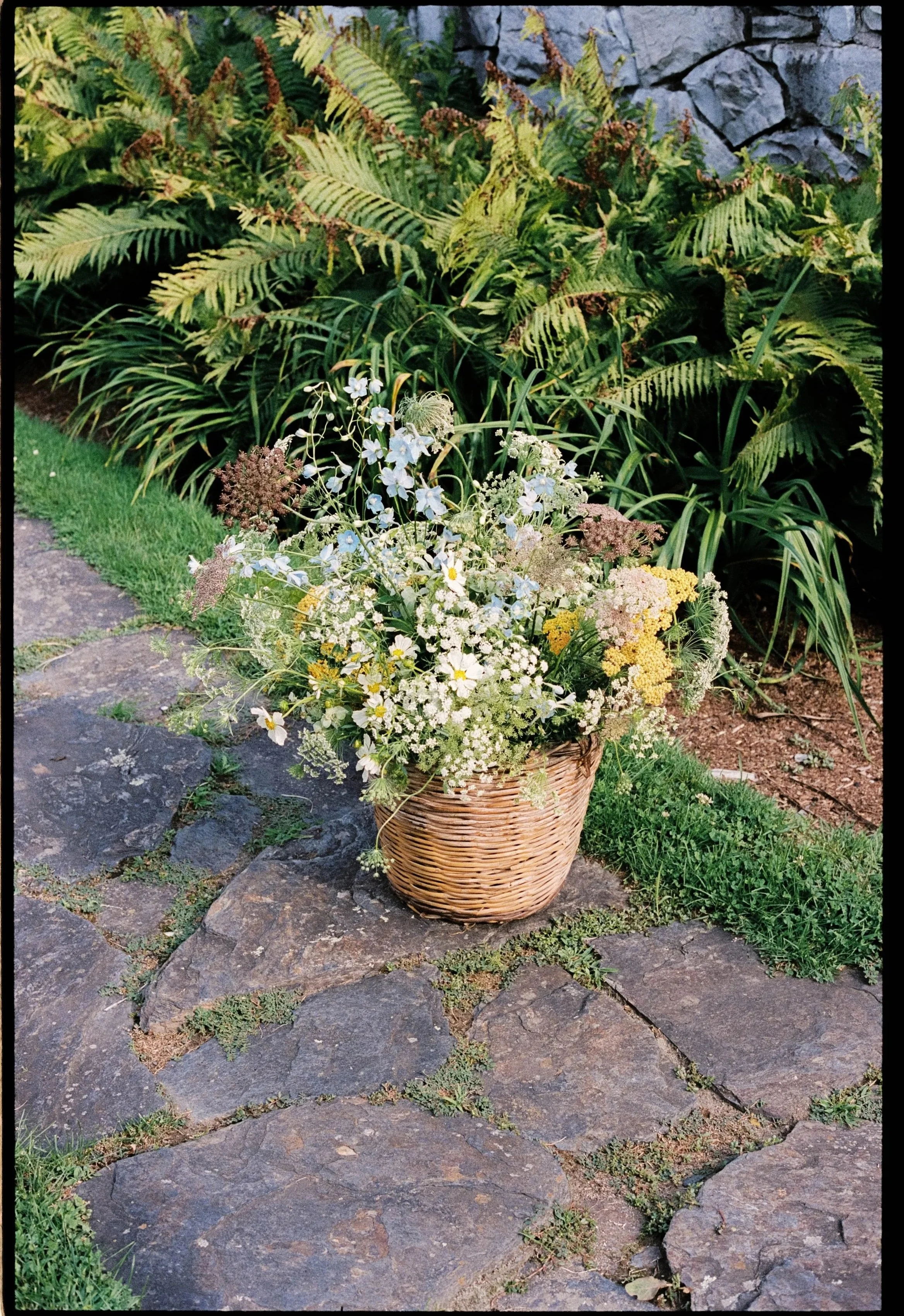 A color film photograph of wedding florals by Pom Shillingford of English Garden Grown, at Troutbeck in Amenia, New York