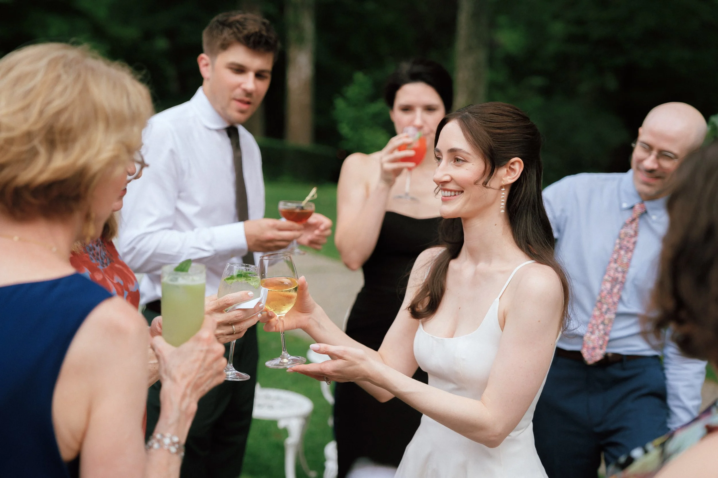 Wedding guests cheersing during cocktail hour at Troutbeck in Amenia, New York
