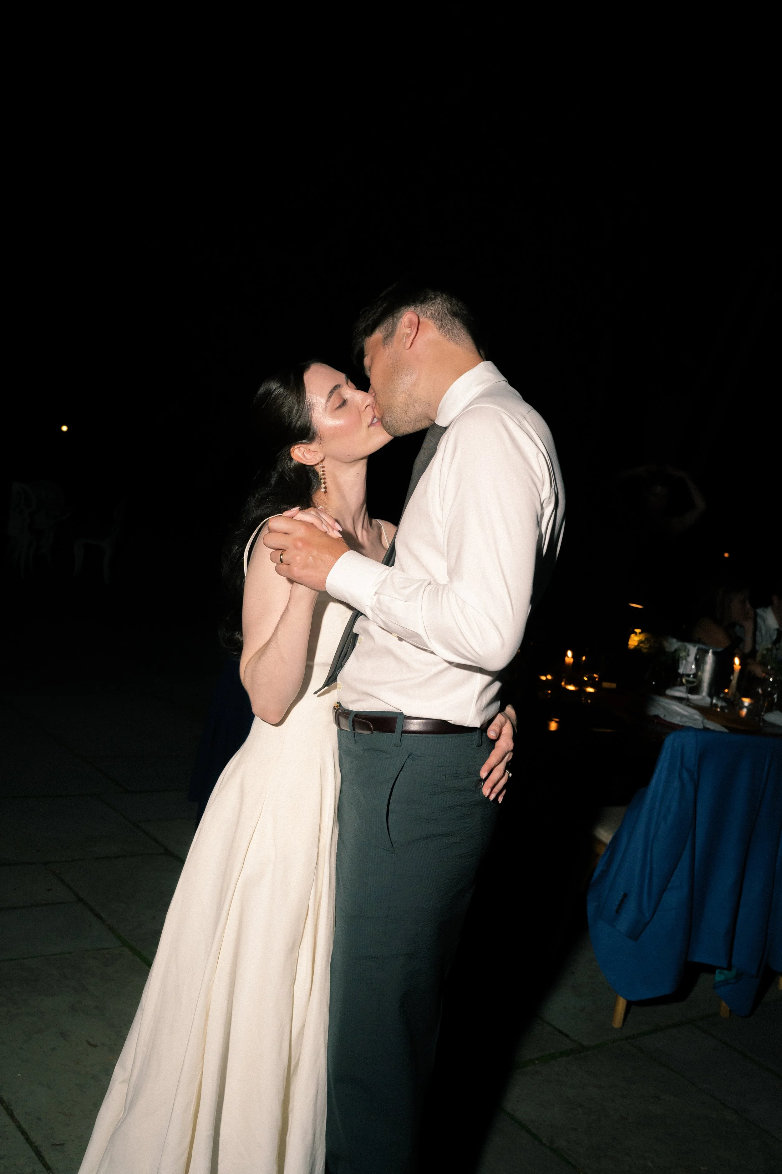 a couple kissing a dancing after their wedding 