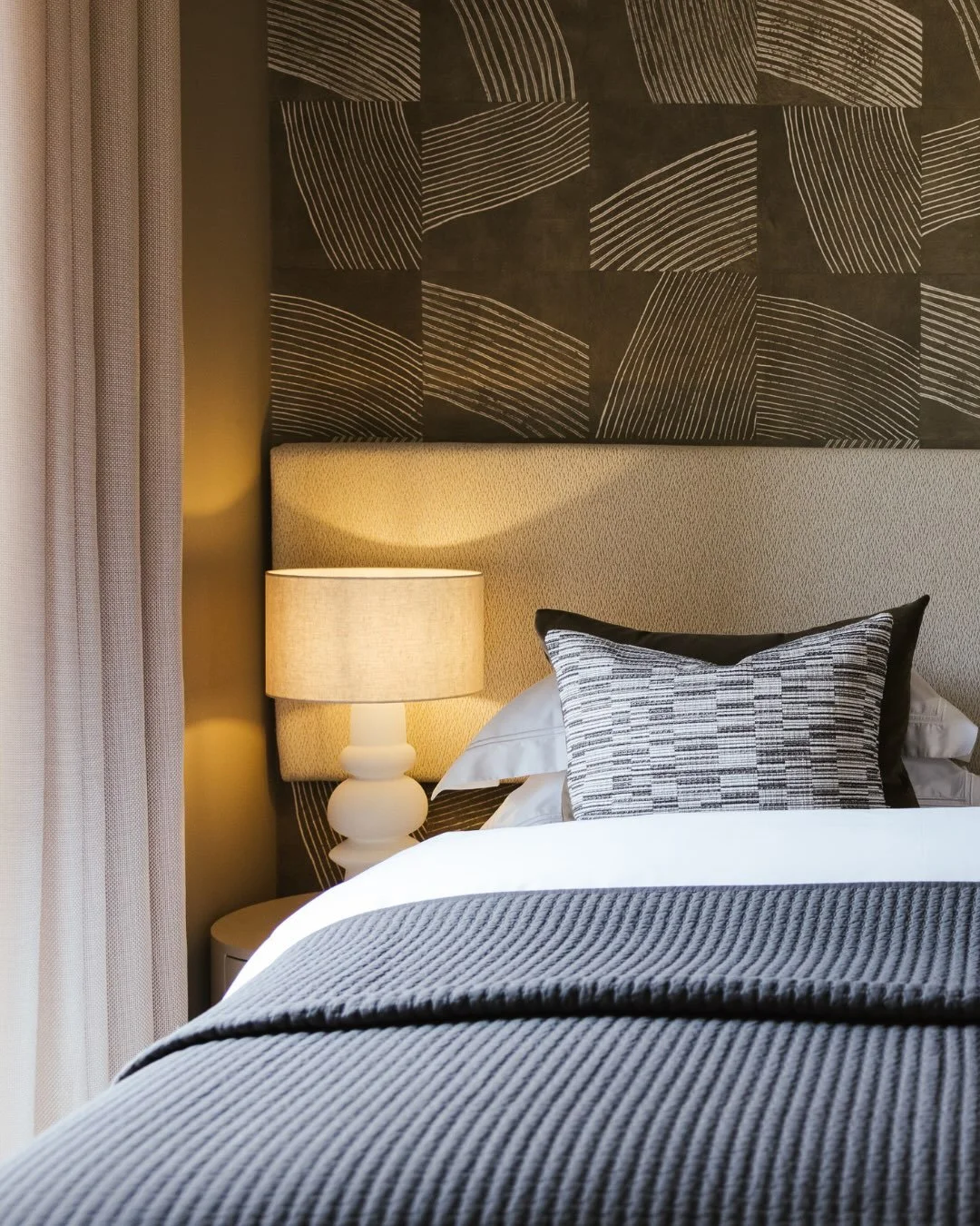We love designing bedrooms that feel a little bit like checking into a boutique hotel, but without losing the comfort of home. 

Soft textures, warm tones layered details create a sense of calm, while the mural brings a little personality and movemen