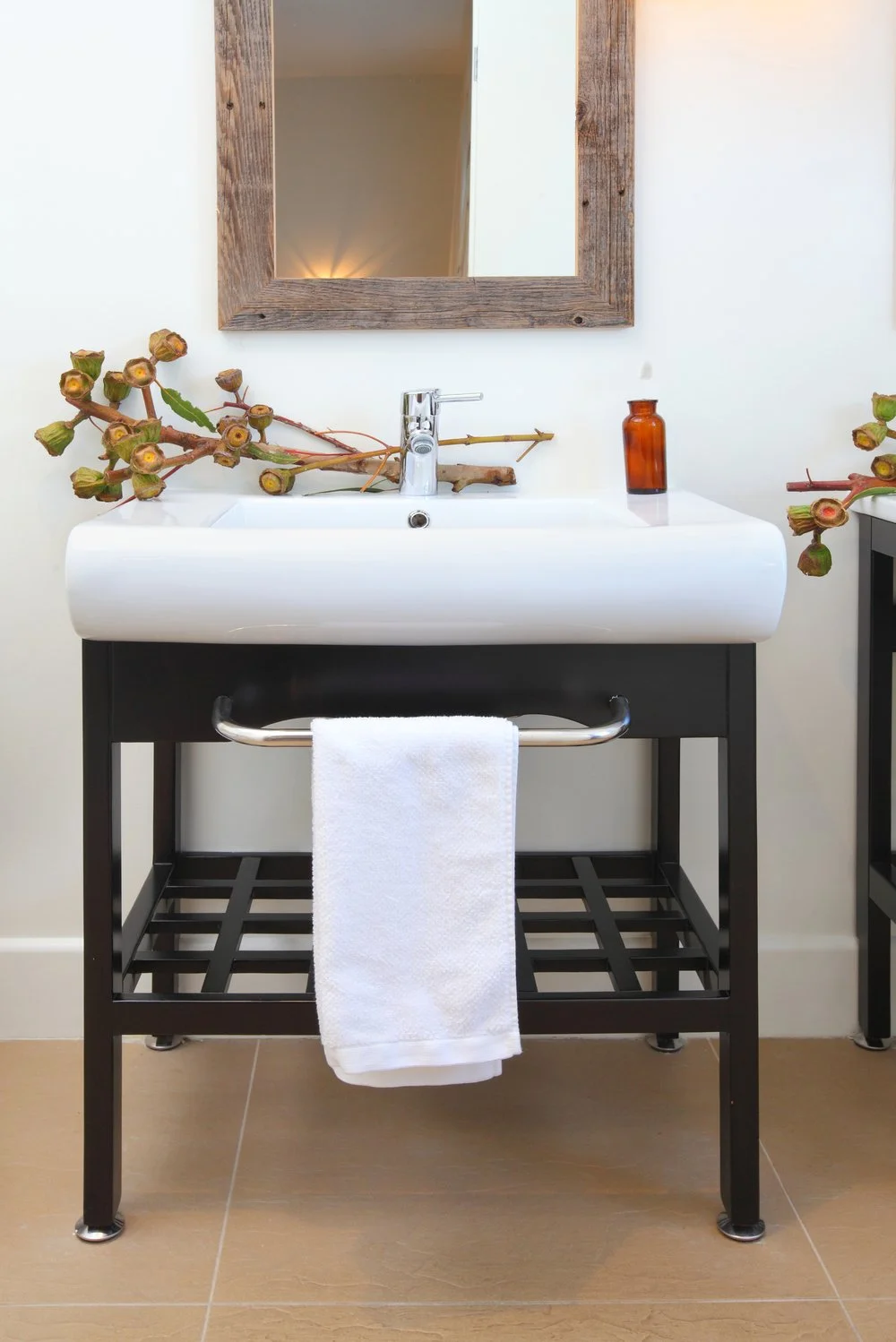 Photo by: Chas Metivier
Stainless steel faucets, integral towel bars and coordinating bathroom accessories meld effortlessly with the deep tones of the ebonized vanity.