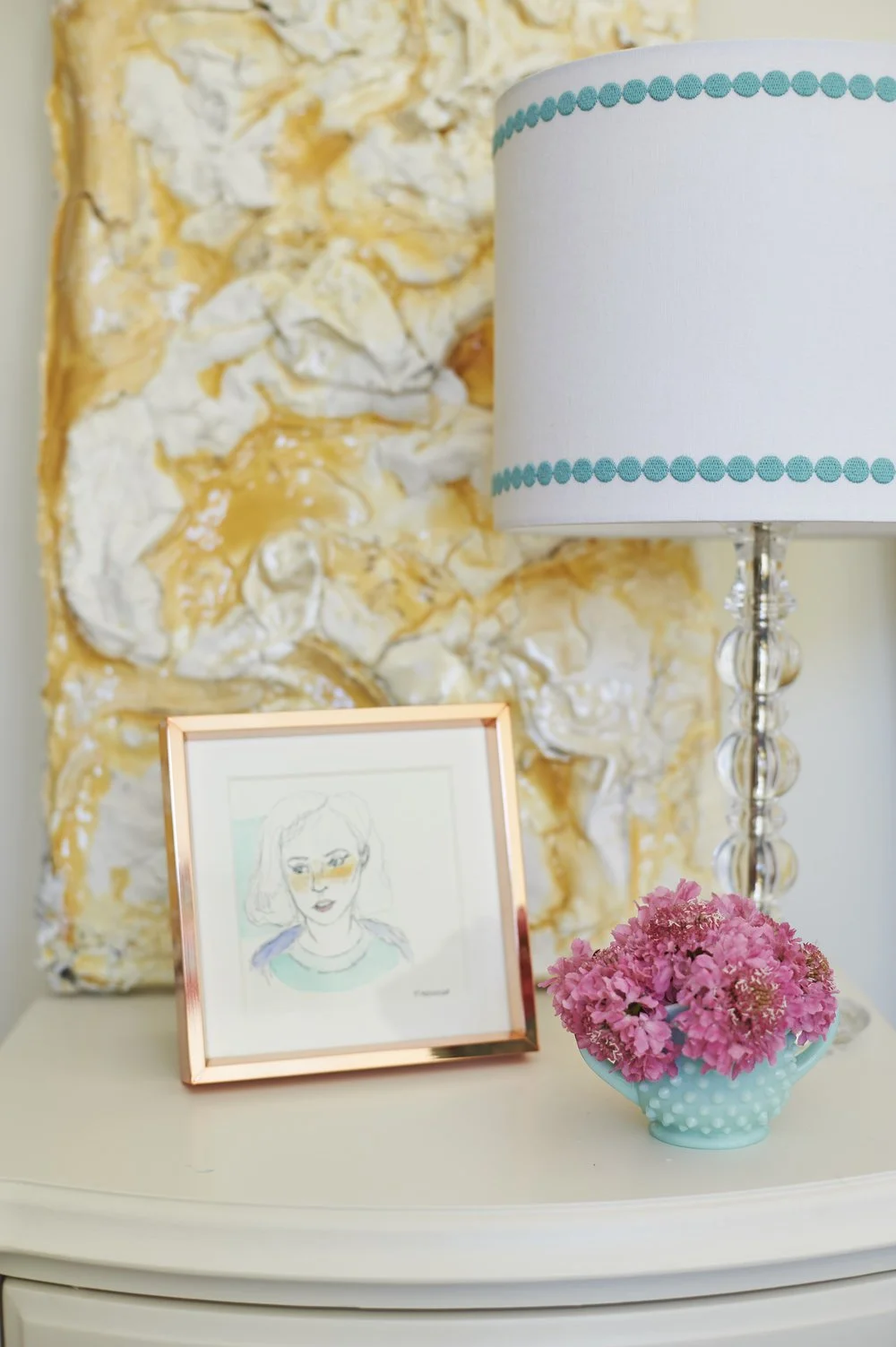Photo by: Steven Dewall
A vintage hobnail glass vase sits among fine art works by Renae Barnard and Melissa Halozan on the teen girl's bedroom nightstand. 