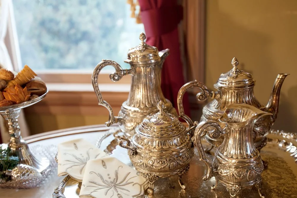 Photo by: Brad Nicol
Antique silver sparkles aside vintage embroidered linens.