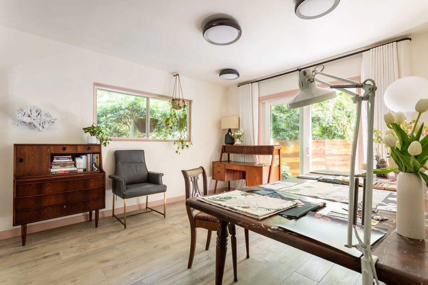 Photo by: Ace Misiunas
This home office features 1960s midcentury Danish-designed pieces such as a grey leather chair, and secretary desk made from Rosewood. A wall-based sculptural work by artist Renae Barnard connects the built and natural environm