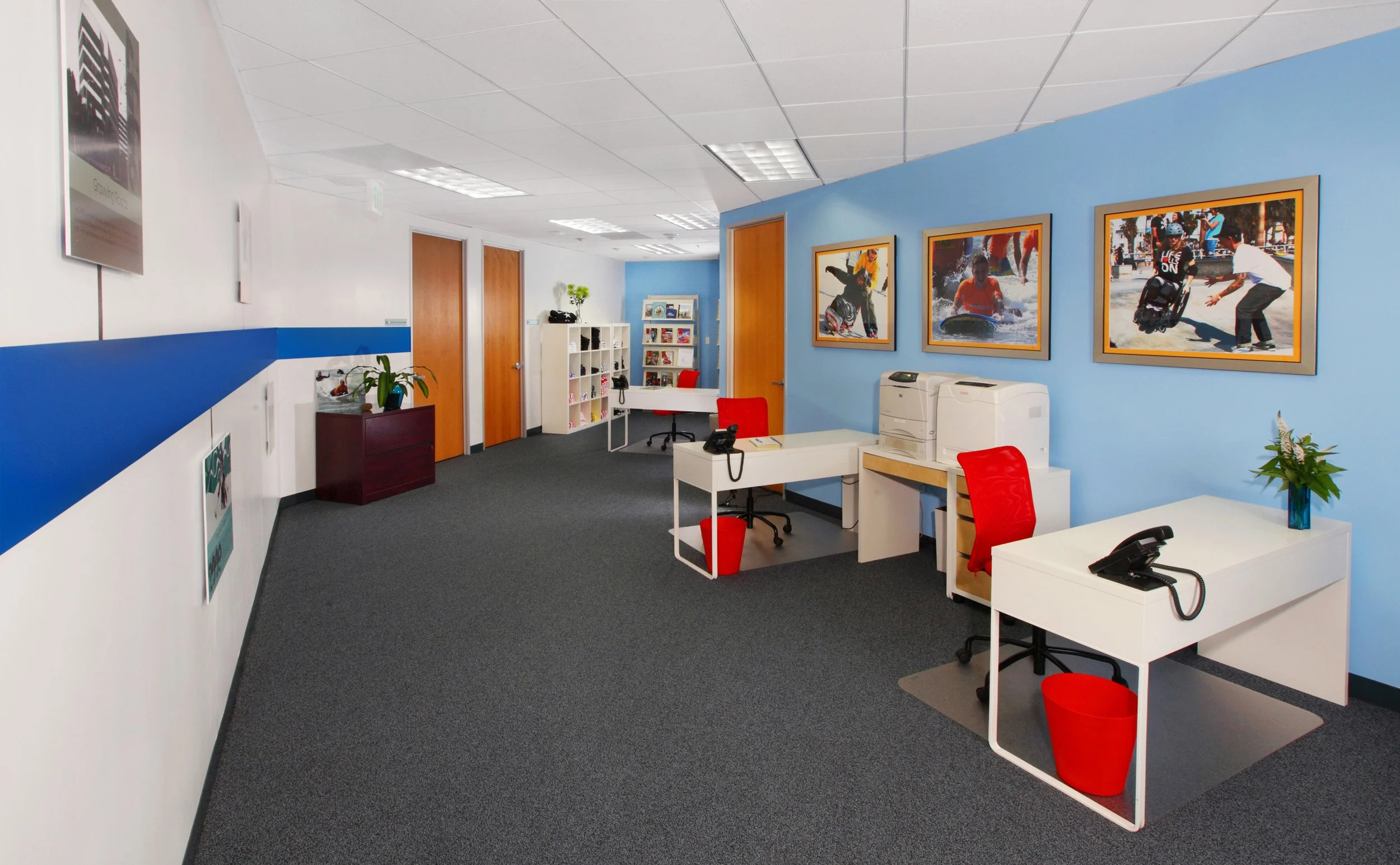 Photo by: Chas Metivier
Using bold colors, graphic signage, and streamlined contemporary furnishings, we promoted an upscale corporate office look on a very tight budget.