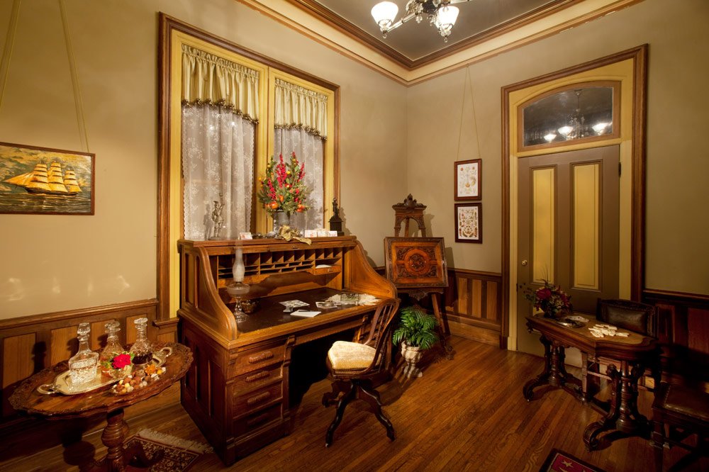 Photo by: Brad Nicol
Mauve, buttercream, and olive green hues set the stage for dramatic, finely carved furnishings and American artwork.