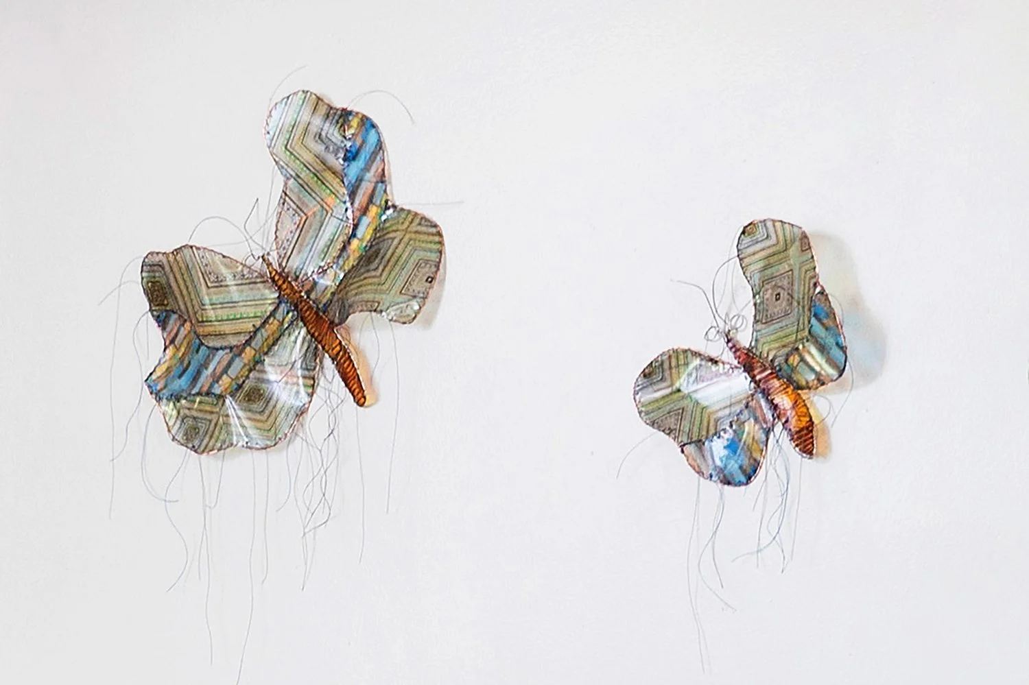 Photo by: Steven Dewall
A series of butterfly sculptures by Gwen Samuels made from images printed on transparent sheets hang above the piano.