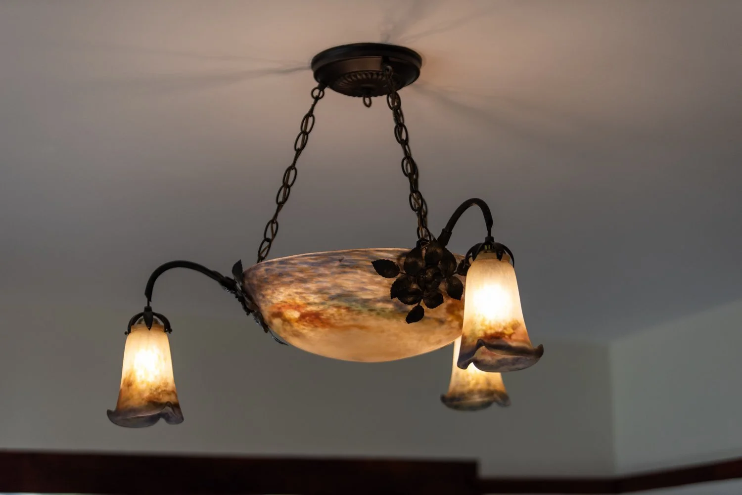 Photo by: Steven Dewall
An Art Deco chandelier by the Muller Brothers of Luneville, France, hangs in the center of the room.