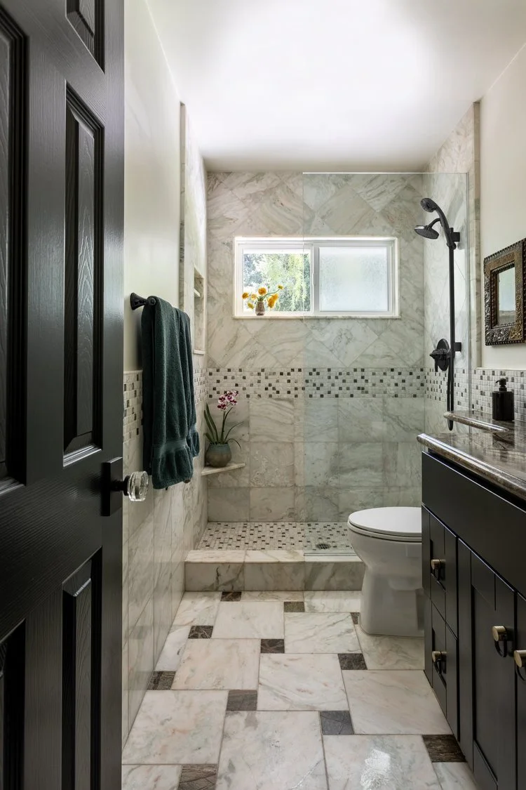 Photo by: Ace Misiunas
The existing cabinets were updated with deep black green paint and round brass hardware with black U-shaped pulls.